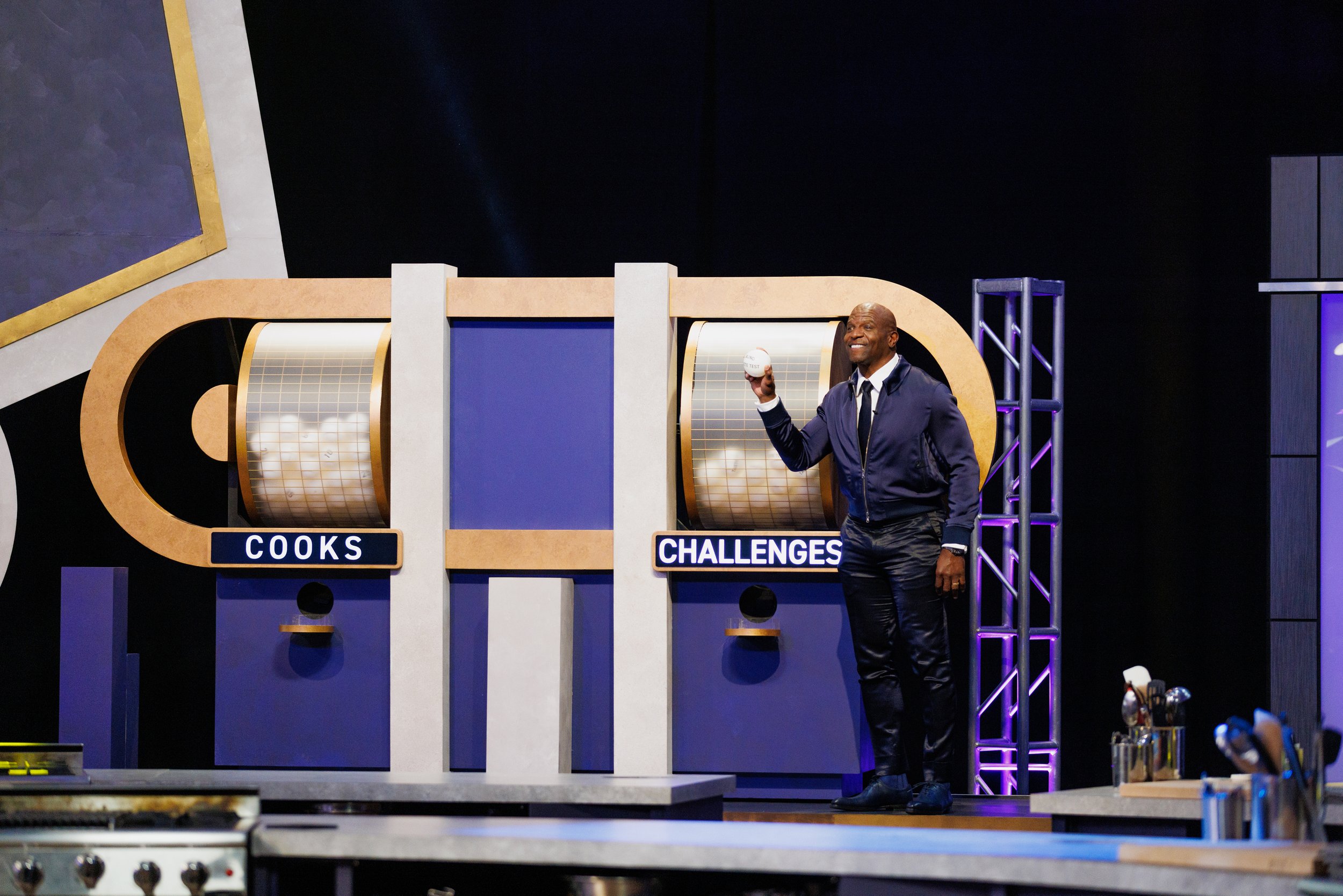 Host Terry Crews with the Cook and Challenge Mixer machines on Food Network's 100 Cooks