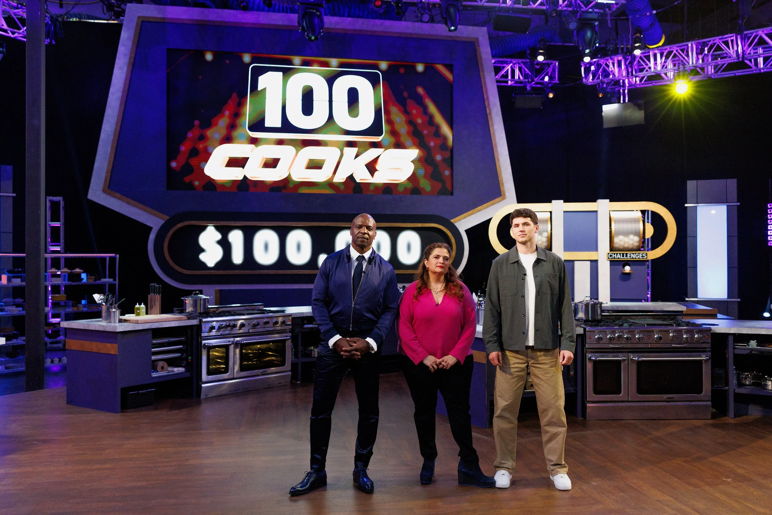 Host Terry Crews with judges Alex Guarnaschelli and Nick DiGiovanni on Food Network's 100 Cooks