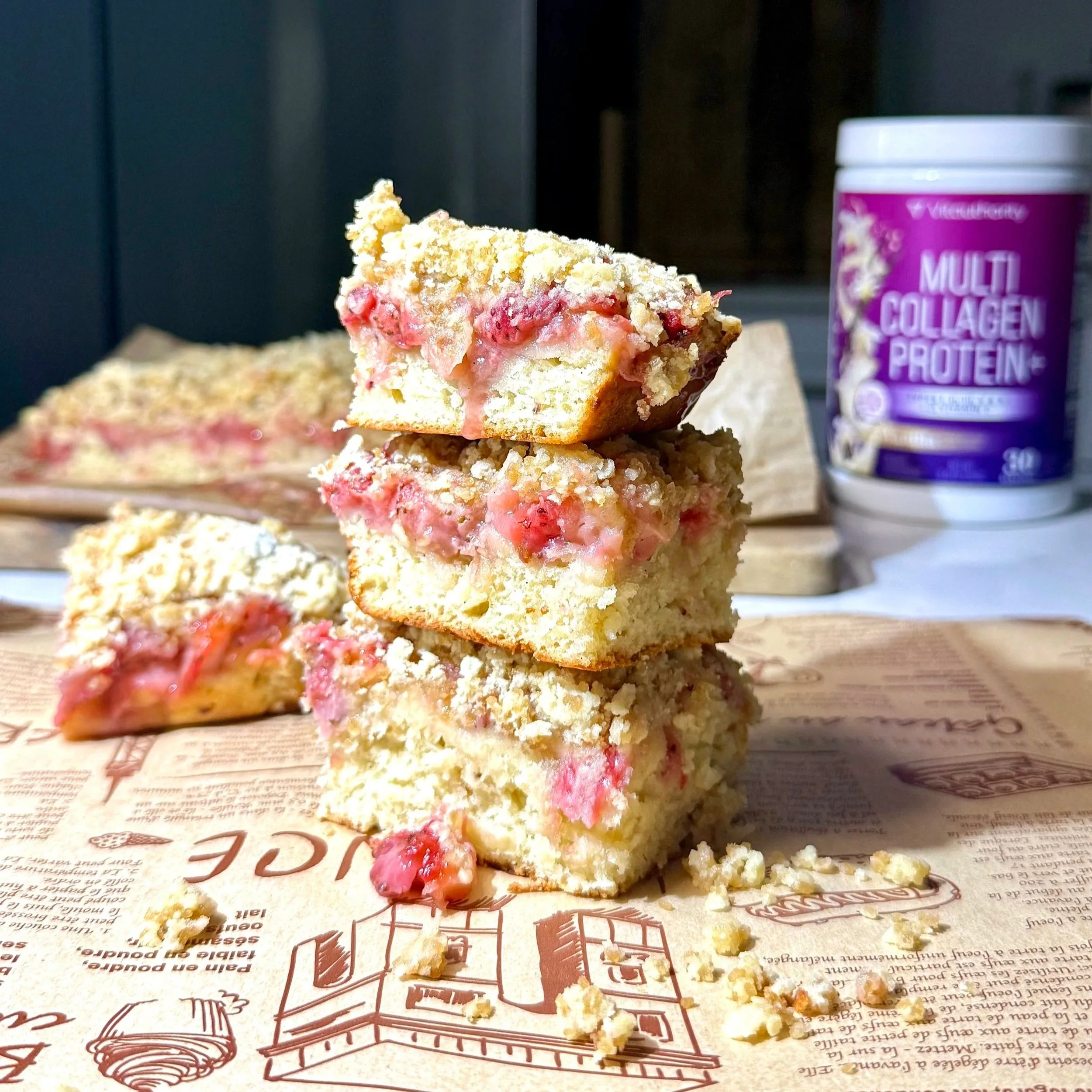Soft strawberry swirl crumble bars stacked with a golden brown crumble and visible jammy strawberry layer.