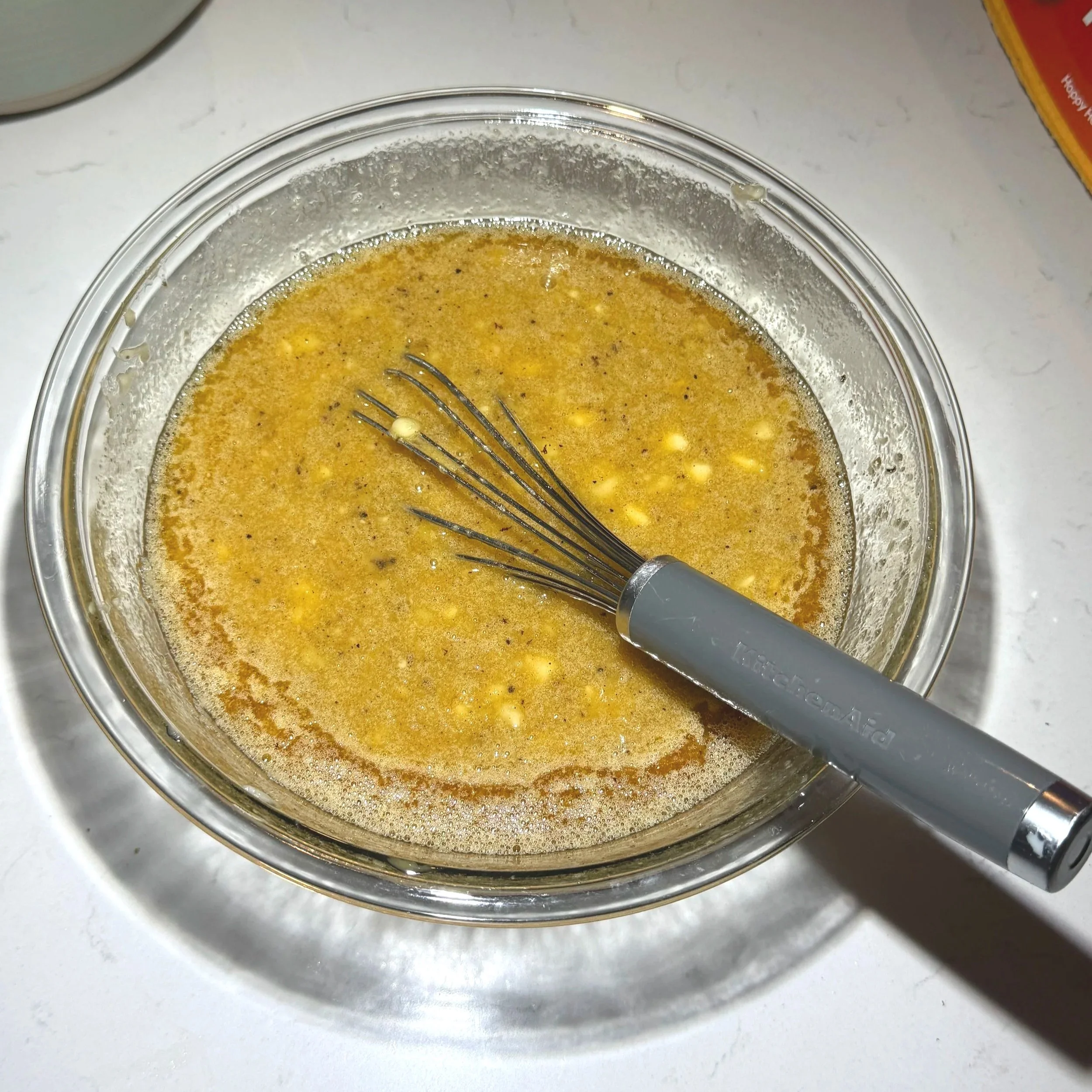 Wet ingredients whisked together with brown butter and mashed banana