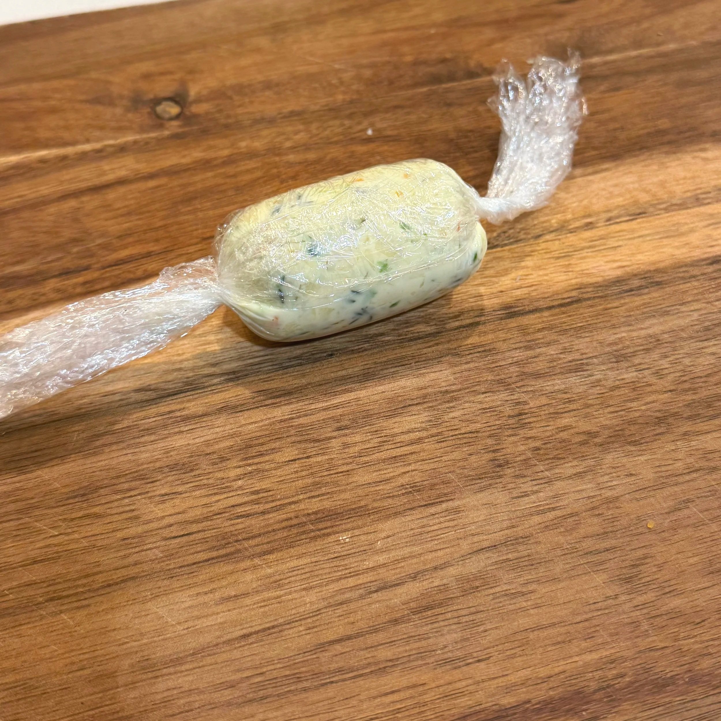 Scotch bonnet garlic butter rolled into a log in plastic wrap
