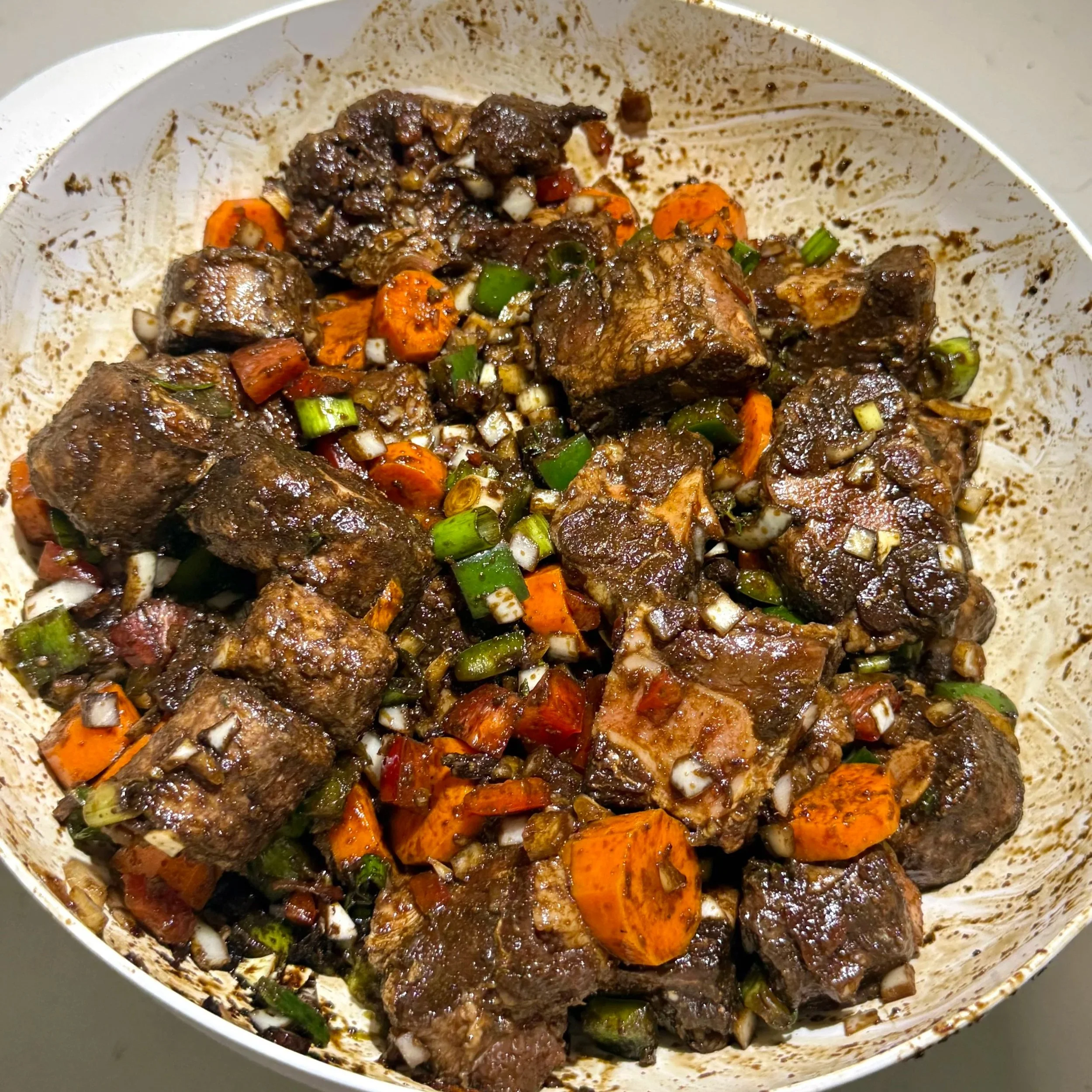 Marinated oxtail with vegetables and seasoning before cooking Jamaican oxtail
