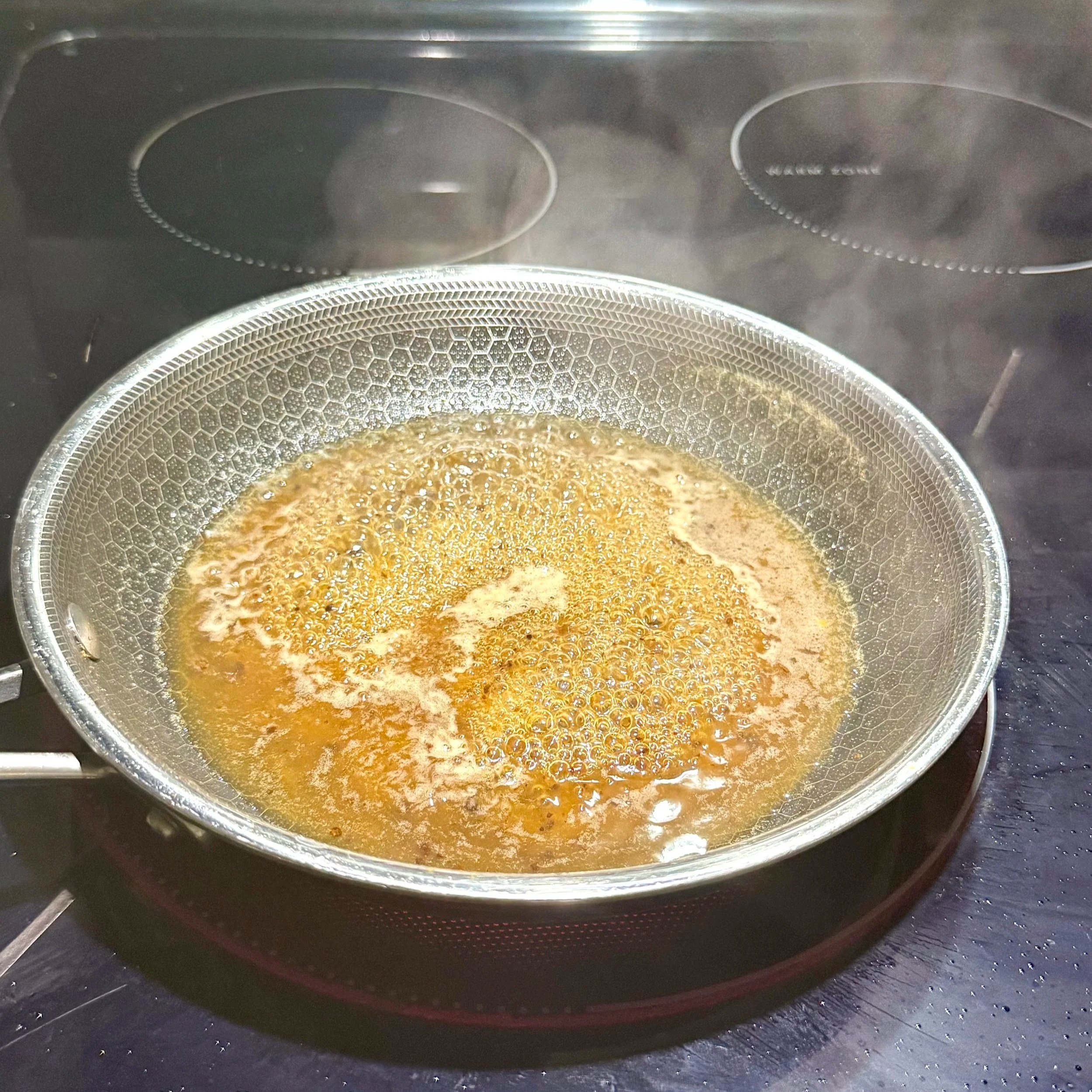 Ingredients for pineapple tamarind gastrique mixed in a saucepan with honey, vinegar, and brown sugar.