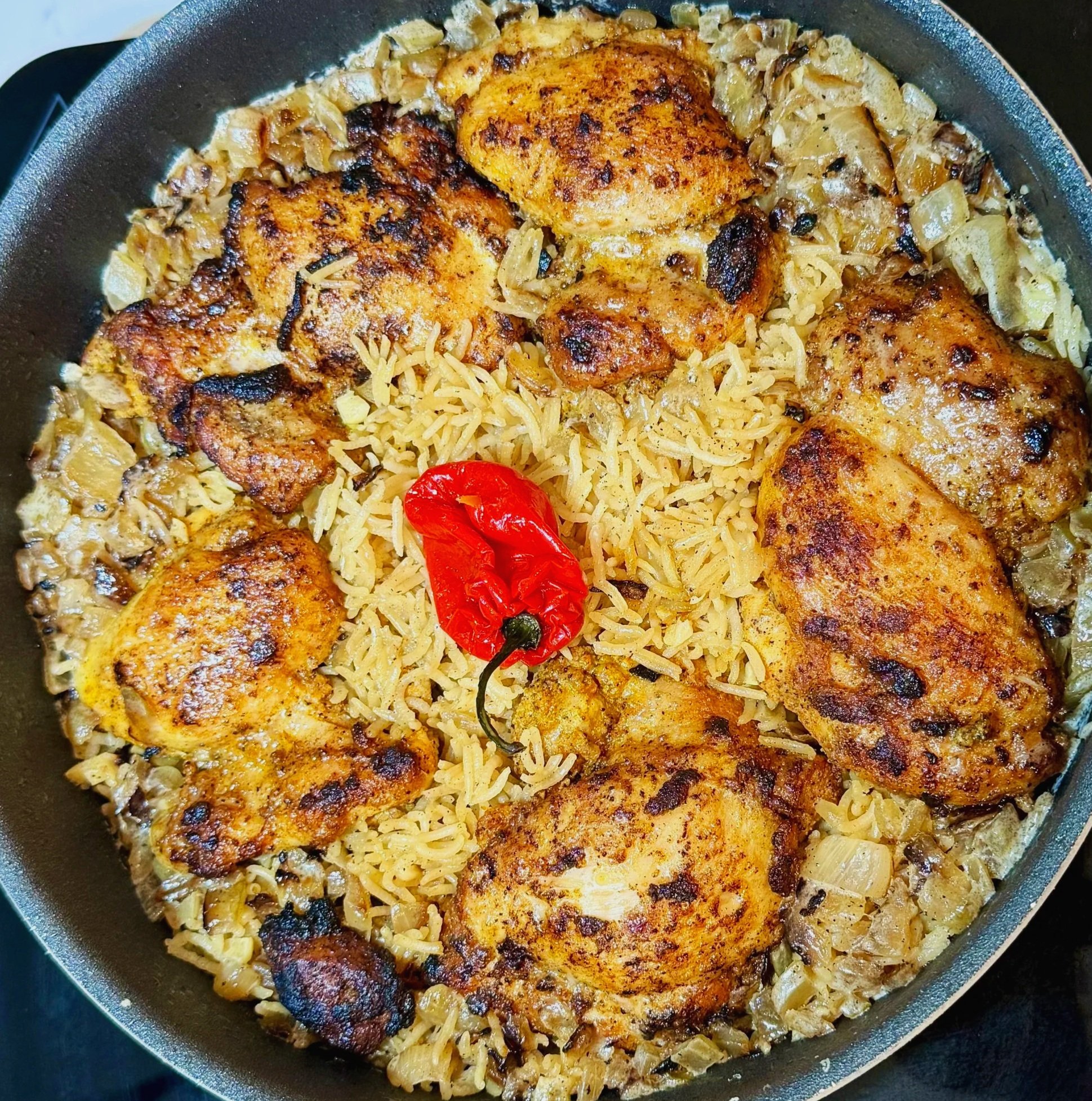Fully cooked coconut chicken and basmati rice in a single pot, rich and aromatic