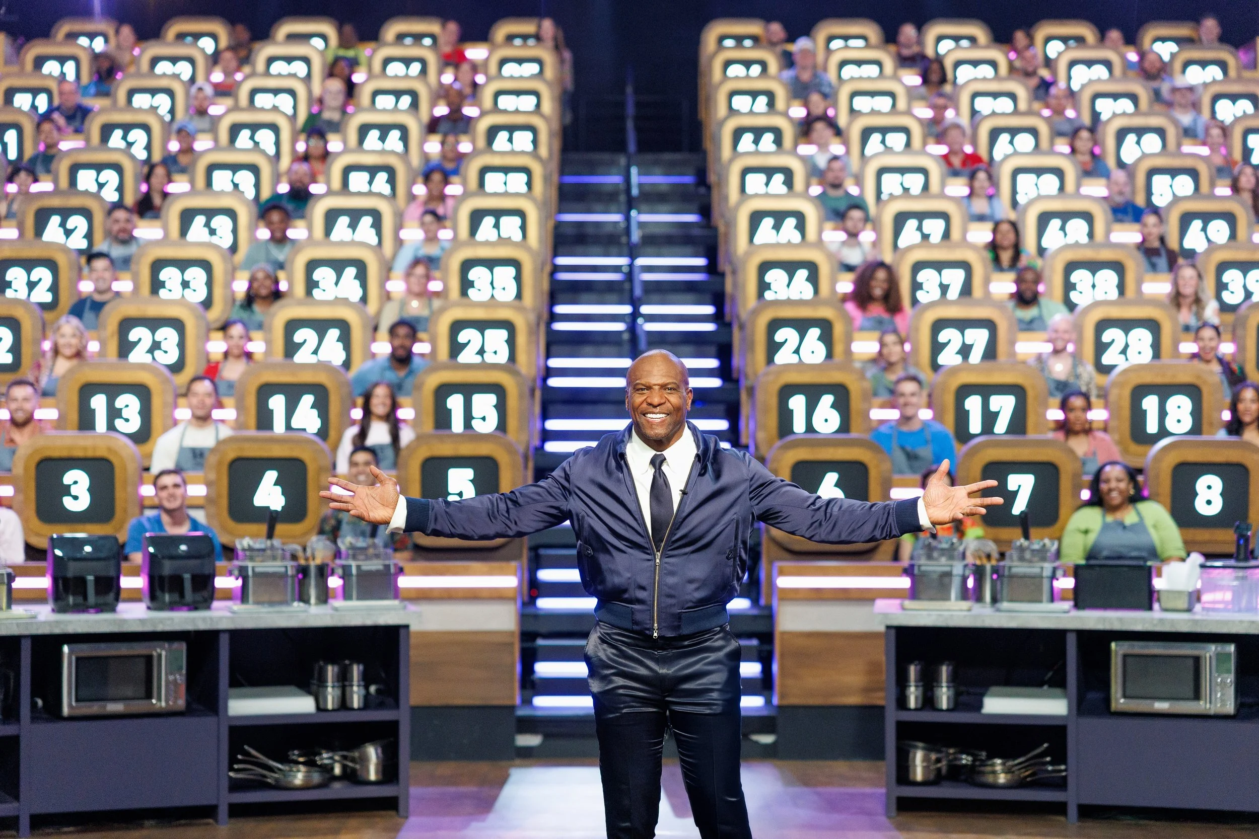 Host Terry Crews welcomes 100 home cooks to the arena on Food Network's 100 Cooks