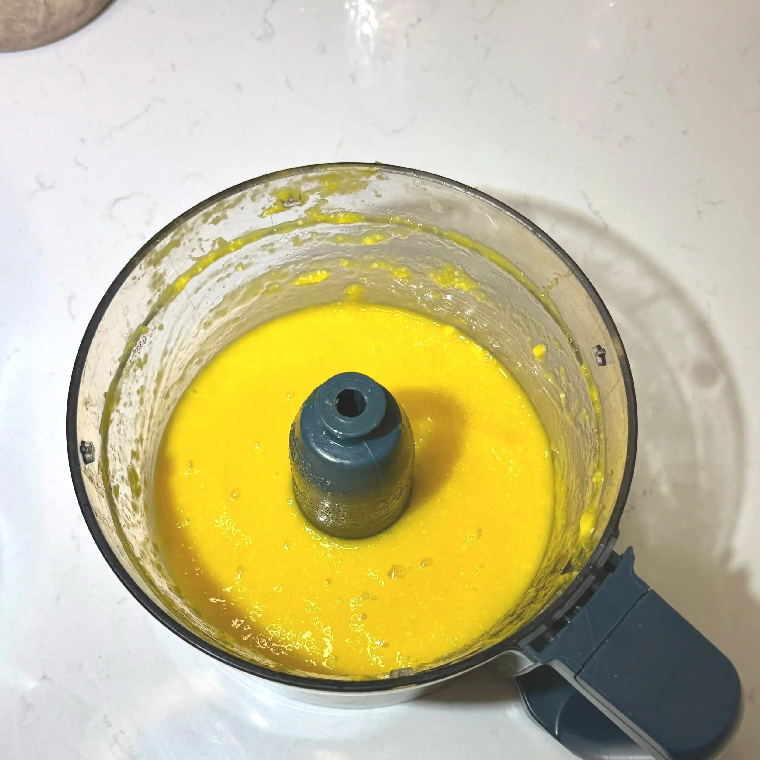 Fresh mango chunks blended into a smooth purée in a food processor