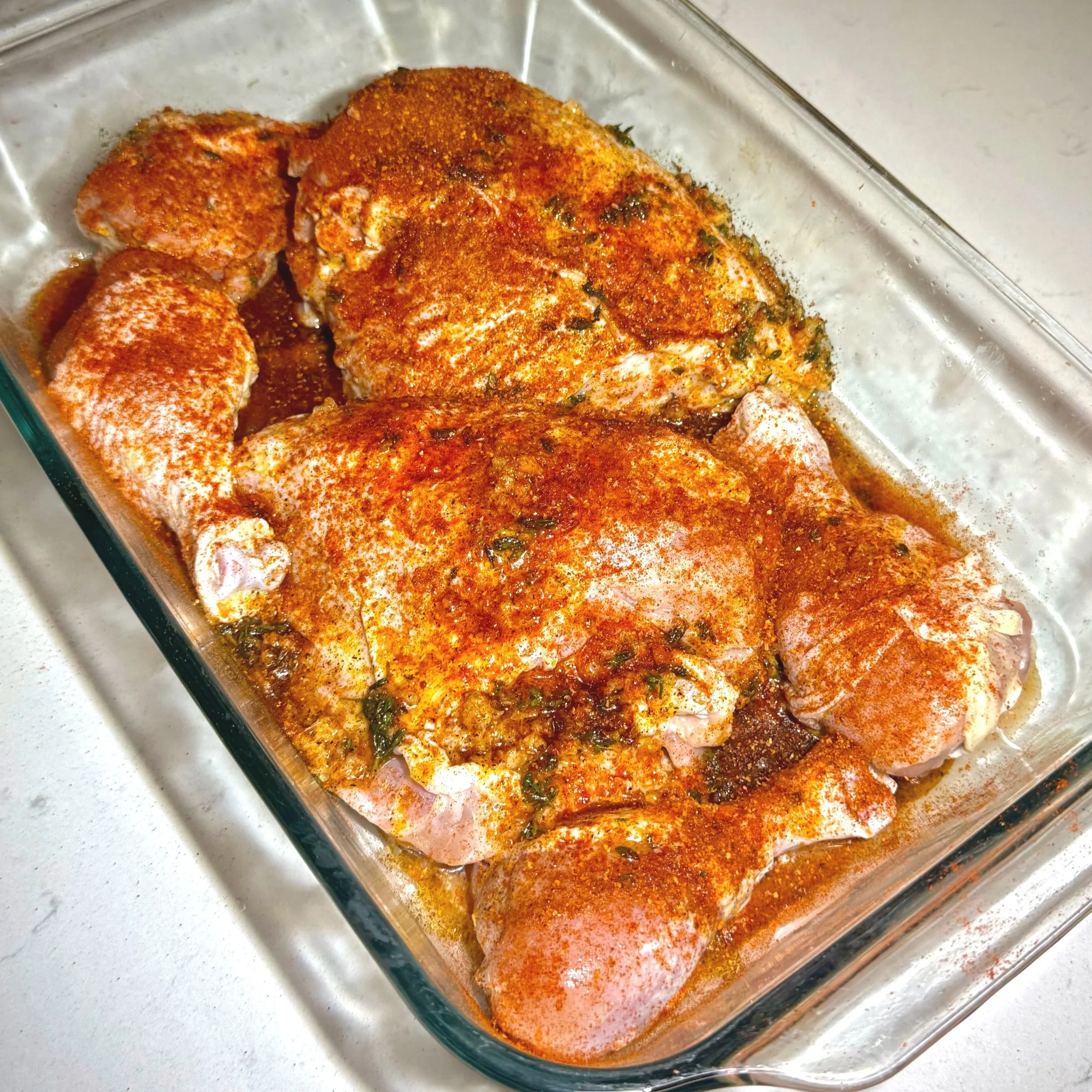Chicken breasts and drumsticks coated in lemon thyme marinade and Hunter’s Poultry Seasoning before baking.