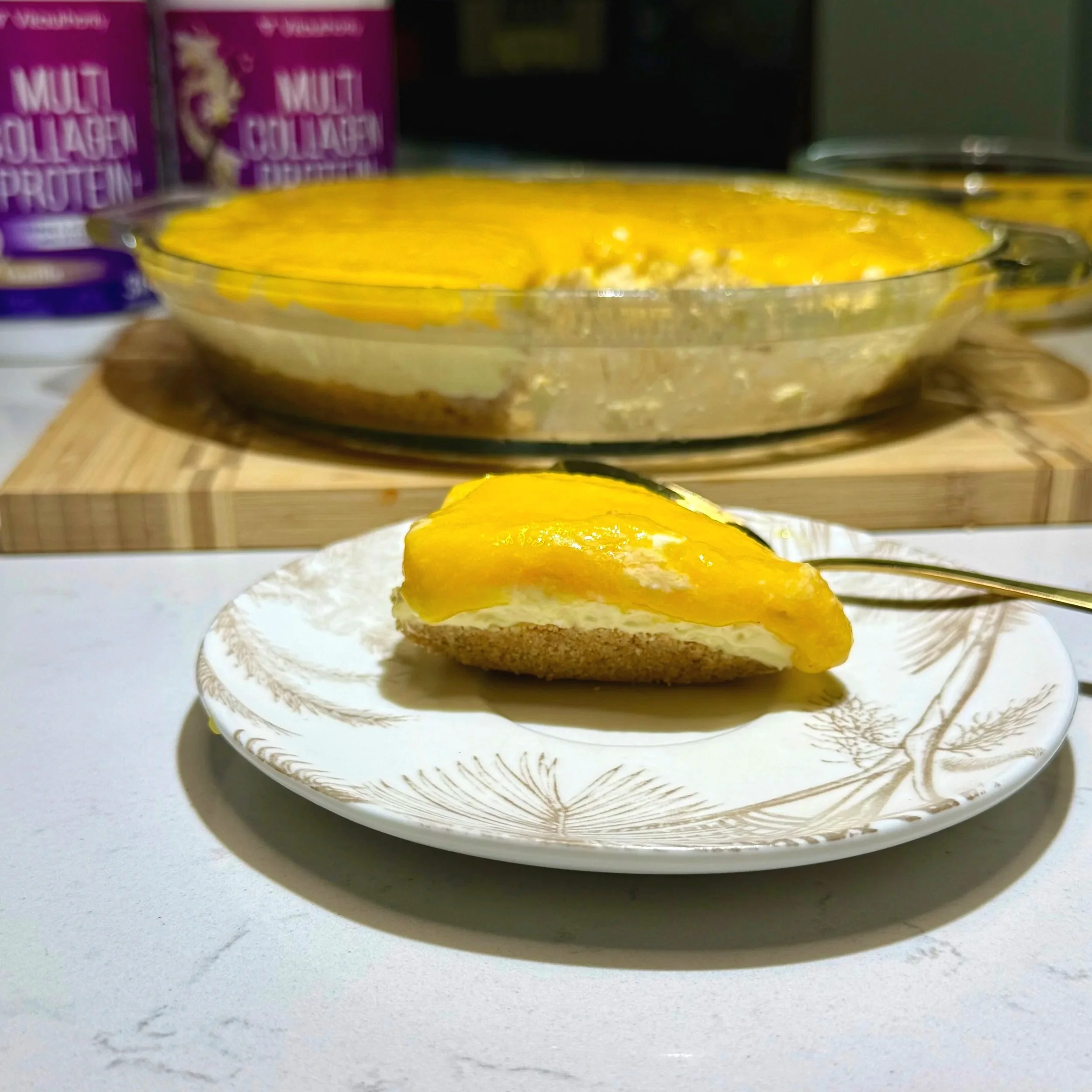 Finished no‑bake mango cheesecake showing clear three‑layer structure