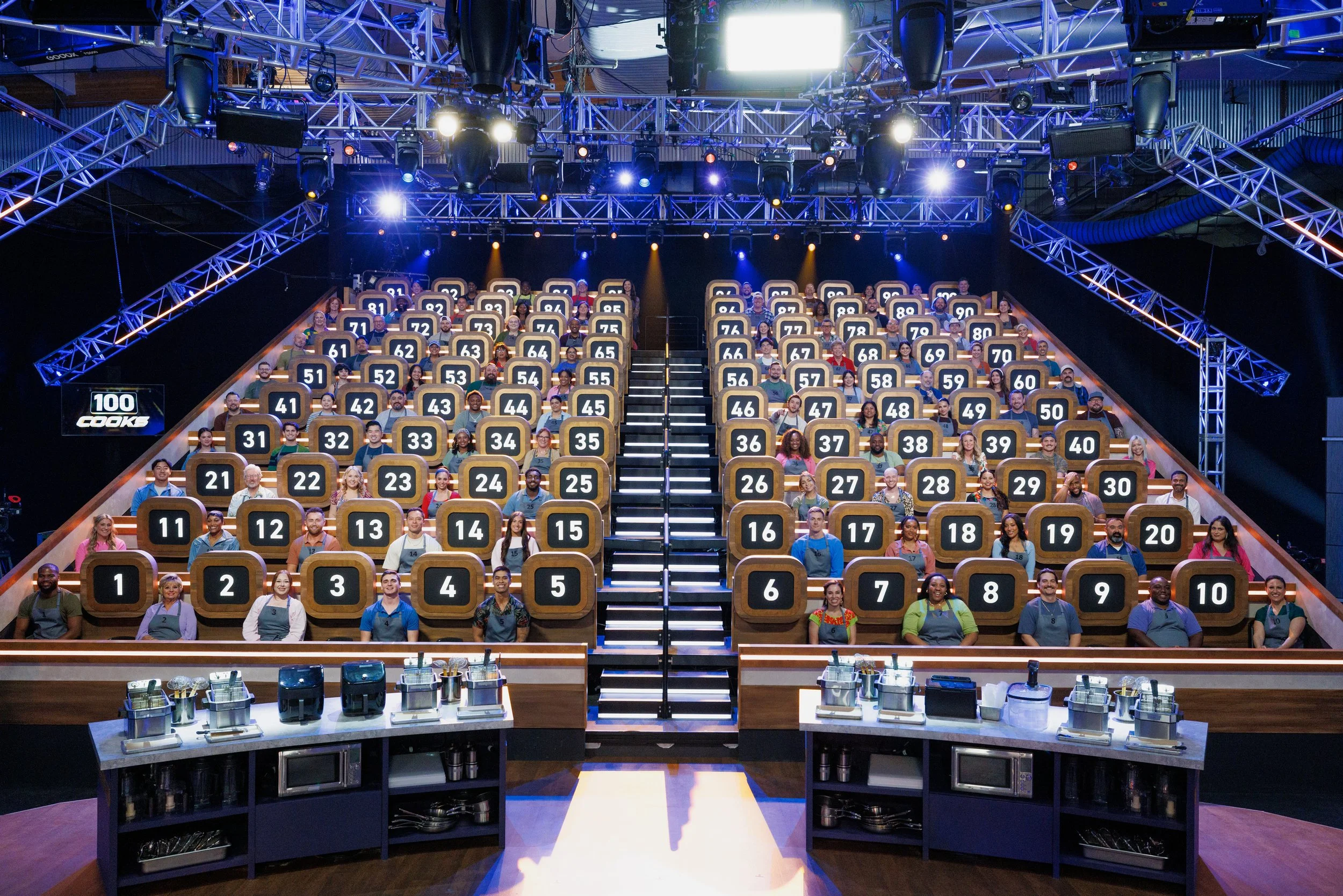 All 100 home cook competitors in the arena on Food Network's 100 Cooks Season 1