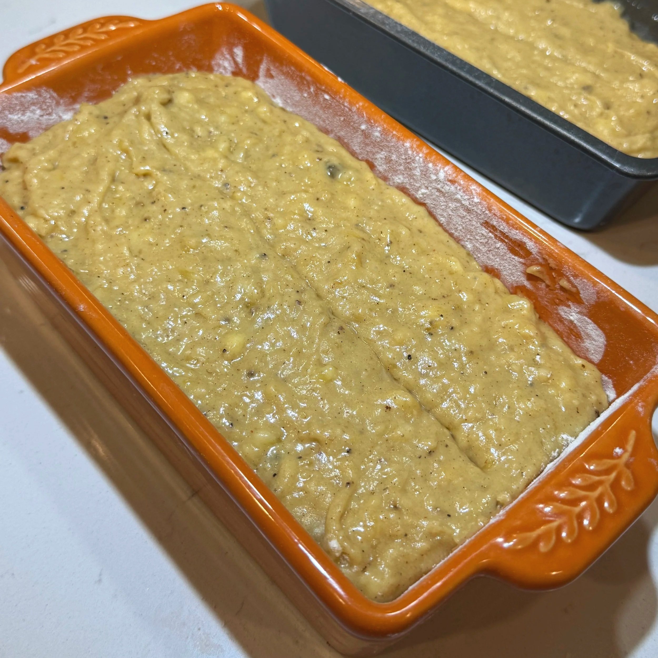 Brown butter banana bread batter poured into a loaf pan