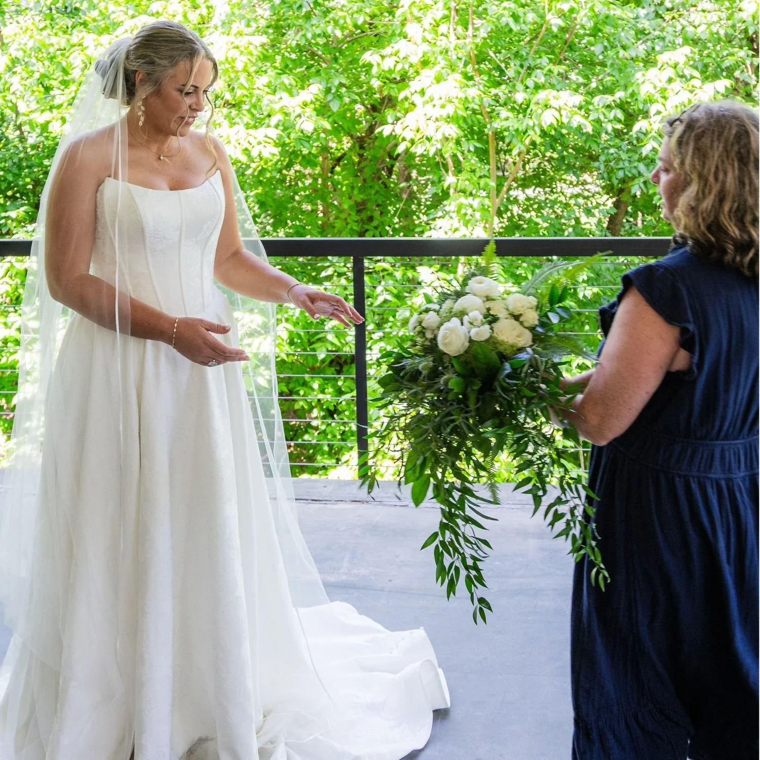 florist handing bride a cascade bouquet