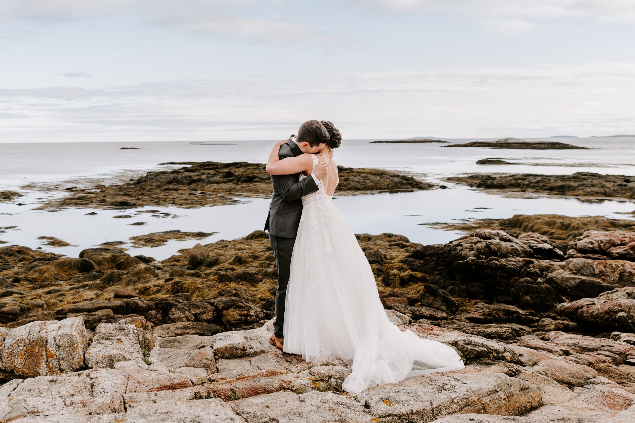 Photo of a couple embracing in coastal maine on their wedding day