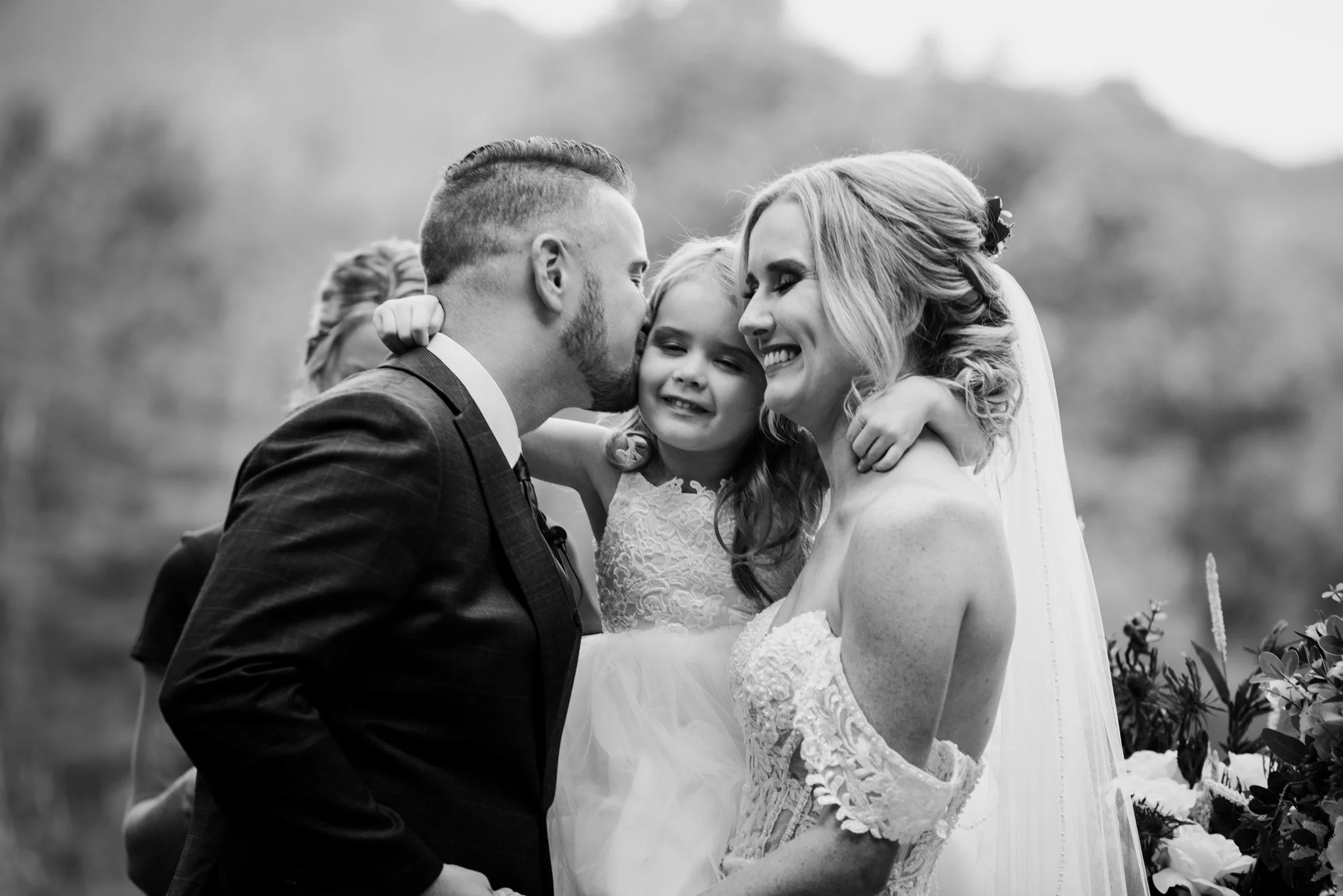 Candid family photo of a bride and groom on their wedding day