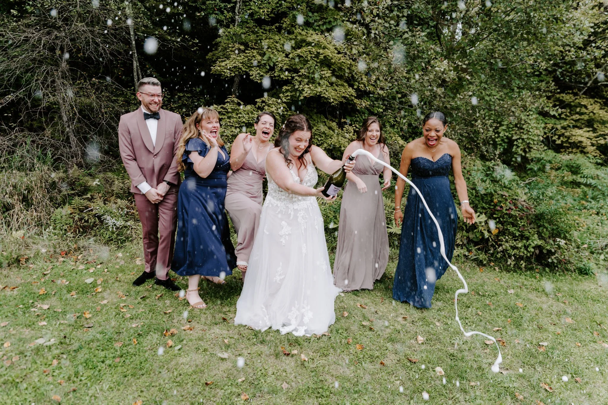 Bridal party portrait with a champagne pop
