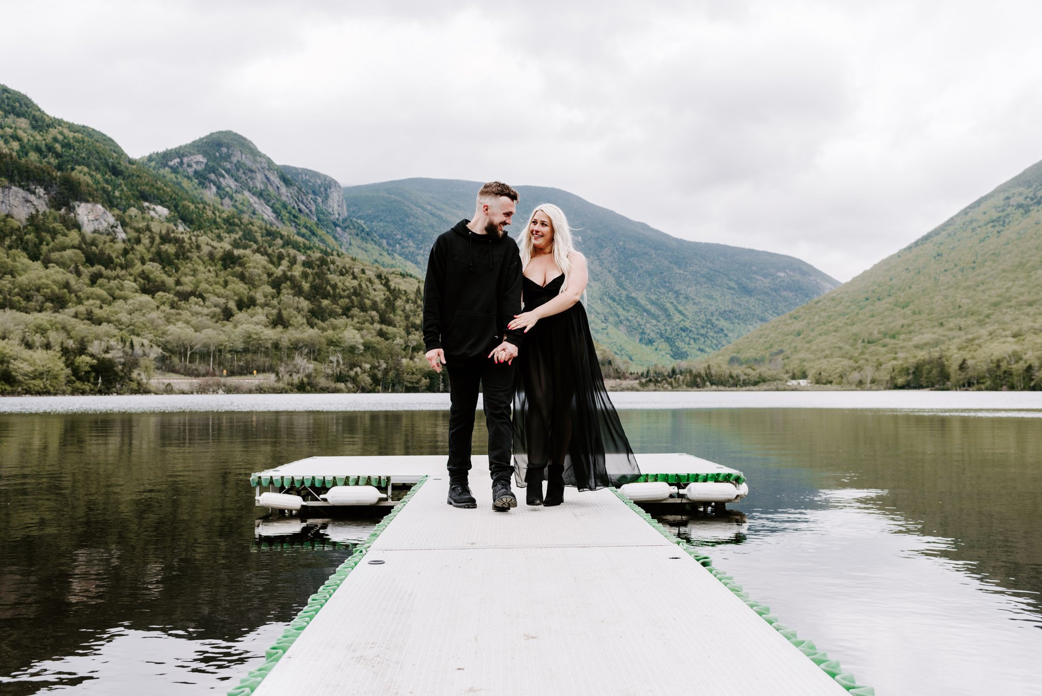Couple dressed in all black celebrating their engagement in the mountains