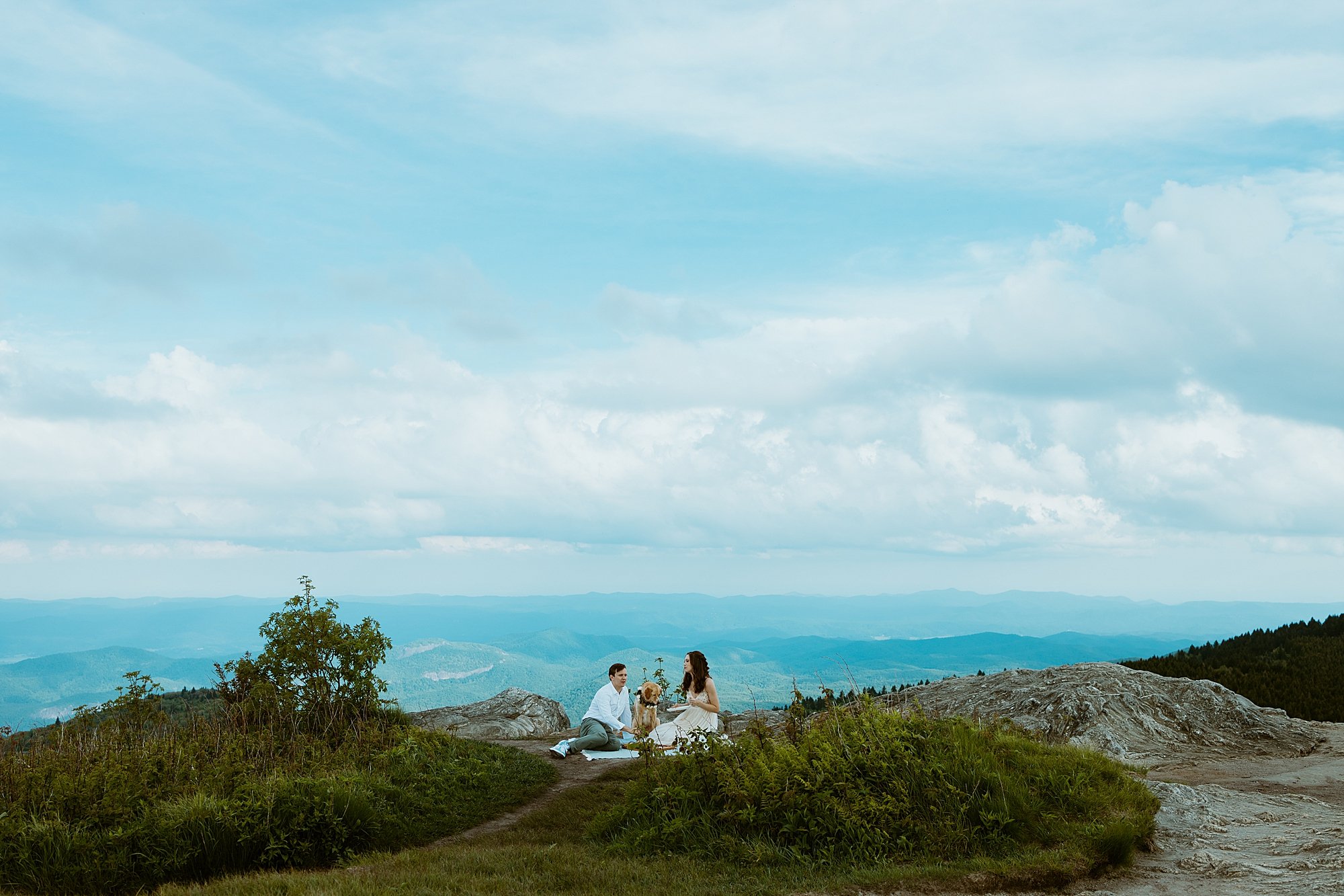 Couple shares a picnic with their dog on top of a mountain after they elope in North Carolina.