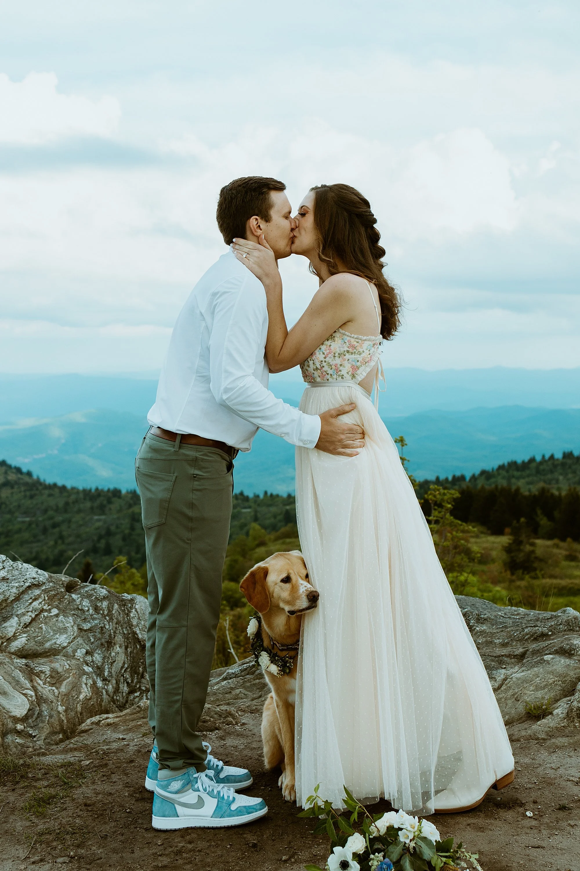 Couple shares their first kiss after their officiant legally pronounces them married while they elope in North Carolina.