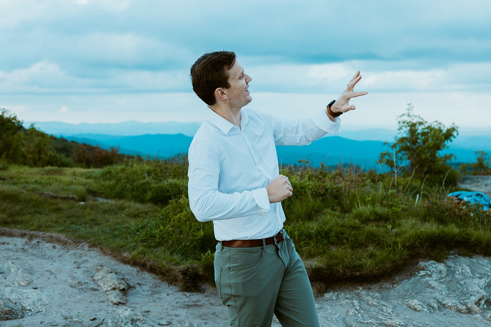 Groom looks happily at his ring after he and his wife elope in North Carolina.