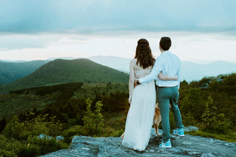 Couple overlooks the blue ridge parkway on top of Black Balsam Knob.