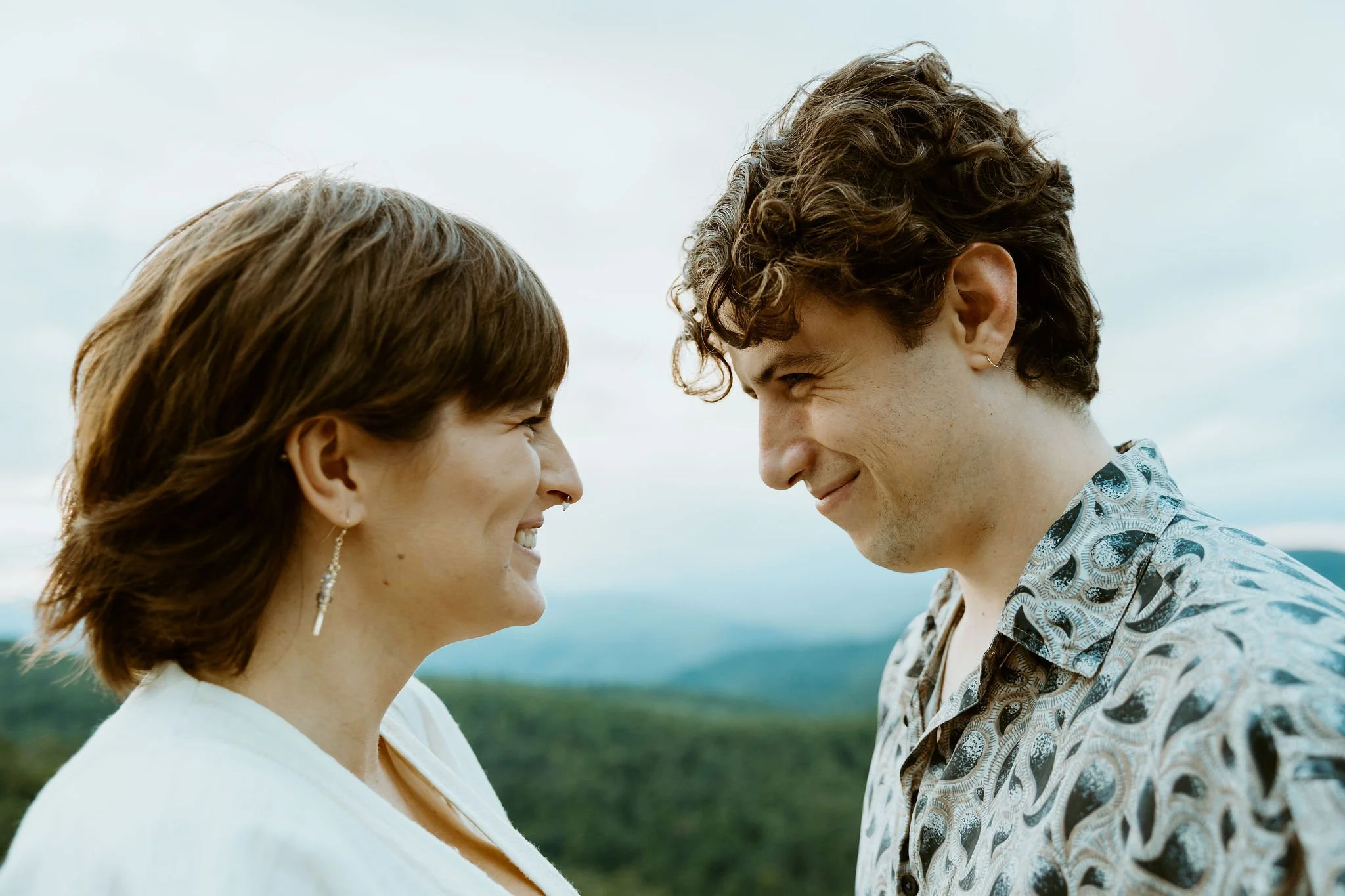Couple smiles at each other after they share their vows while they elope in North Carolina.