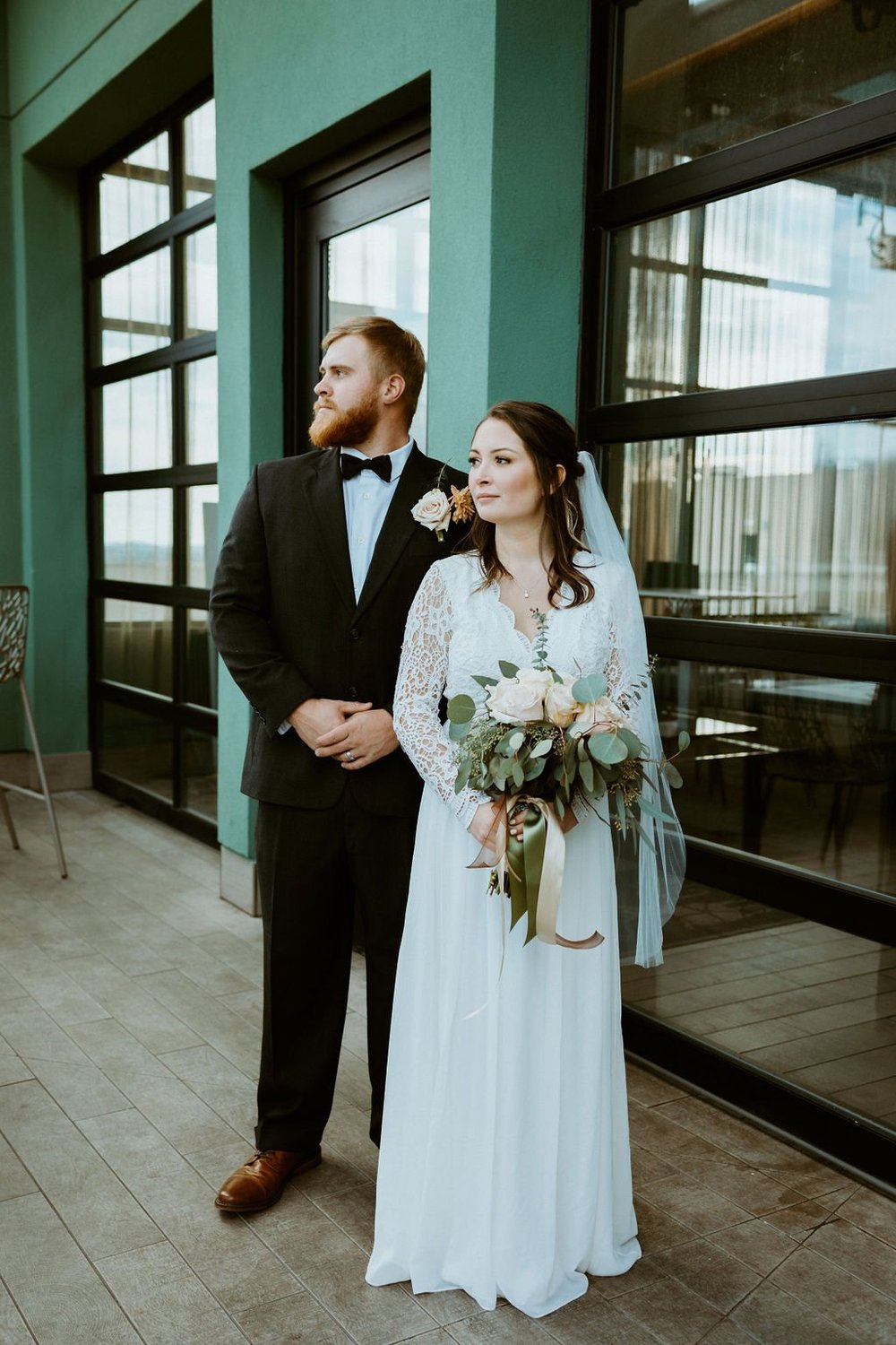 Couple stands on top of the AC Hotel before they head to the blue ridge parkway to share their private vows.
