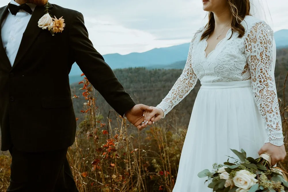 Couple walk along the blue ridge parkway before they share their private vows after their official wedding.