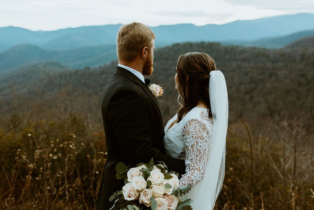 Couple overlooks the blue ridge mountains after they elope in North Carolina.