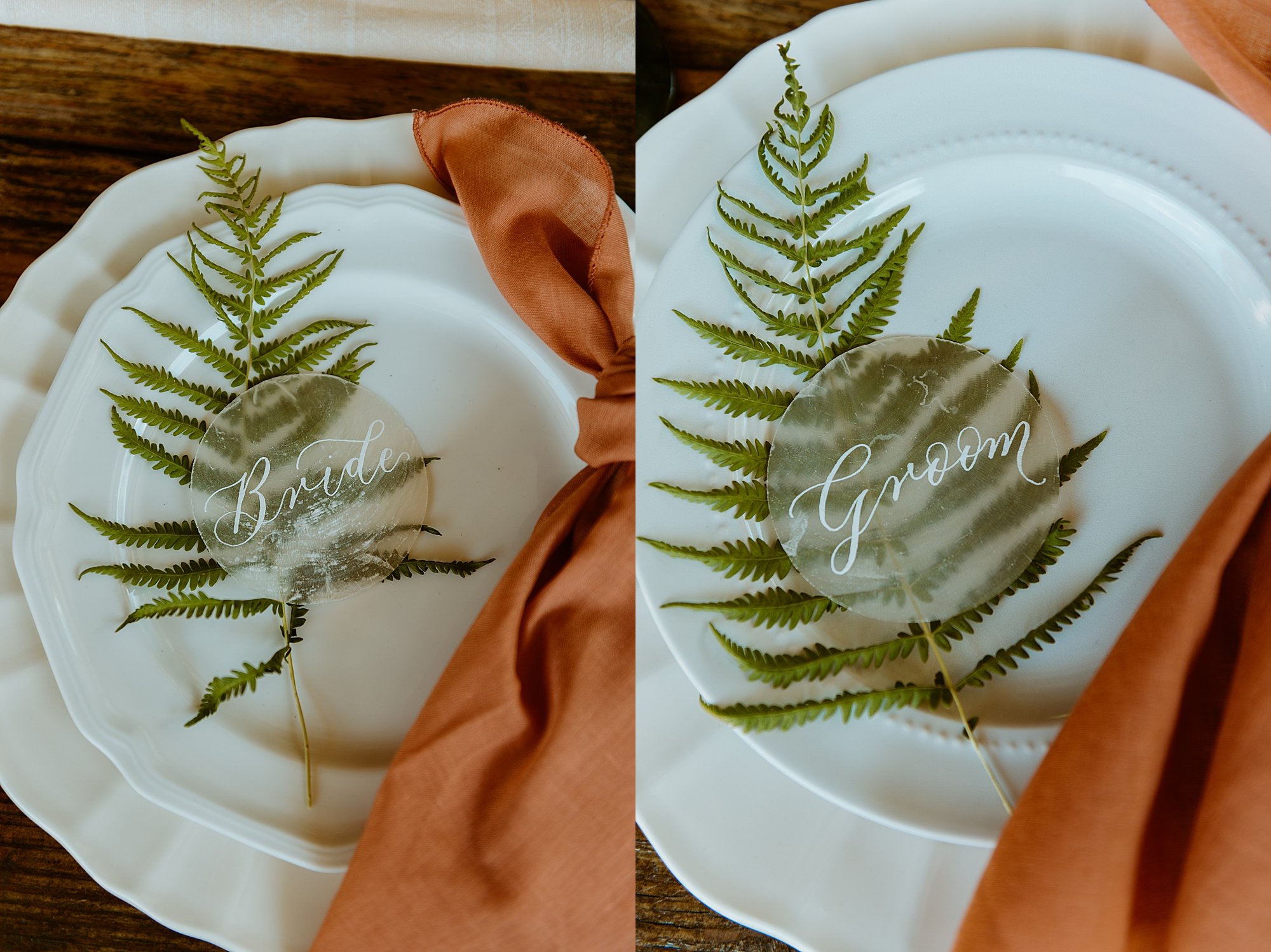 What is an elopement? Plate setting details, white plates stacked with an orange linen napkin, a fern, and a pearl Bride and Groom sign on top