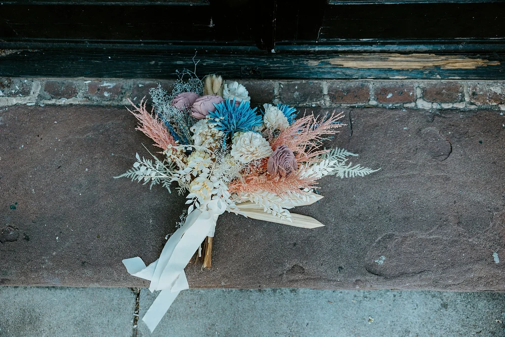 Bouquet sits on a step of a house on Rainbow Row in Charleston SC