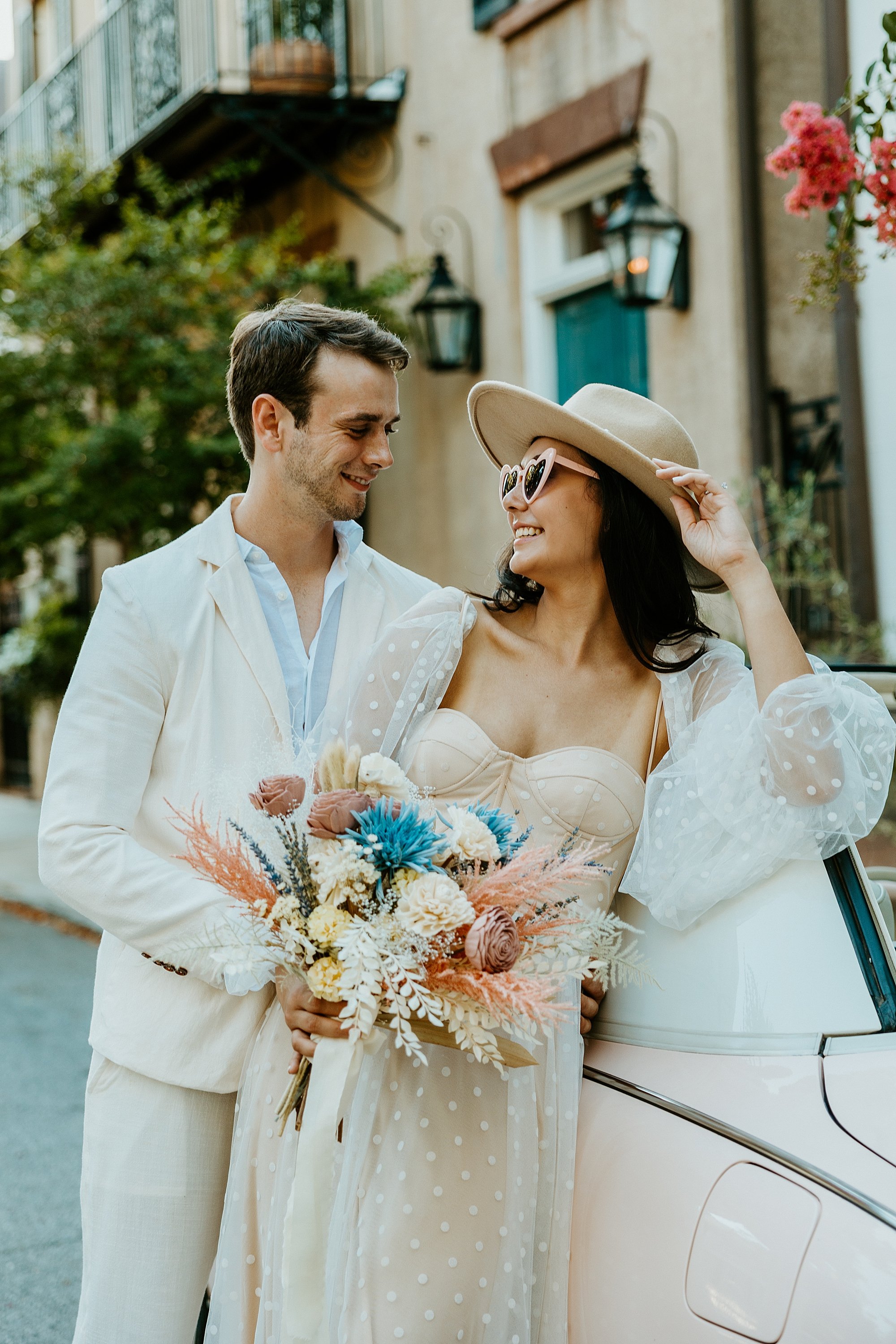 How to elope in Charleston SC. Couple leans agains The Pink Figgy