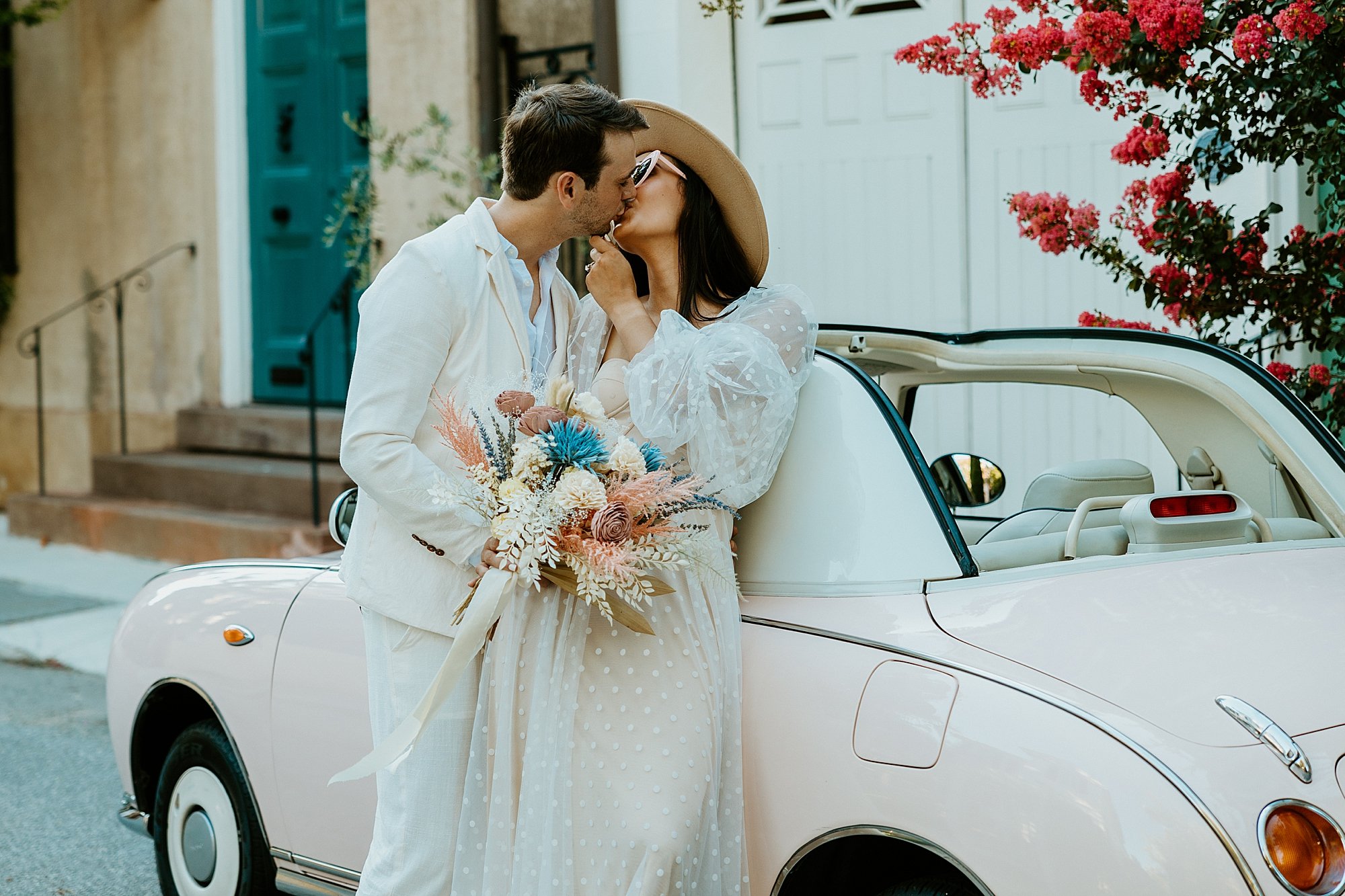 How to elope in Charleston SC. Couple leans agains The Pink Figgy