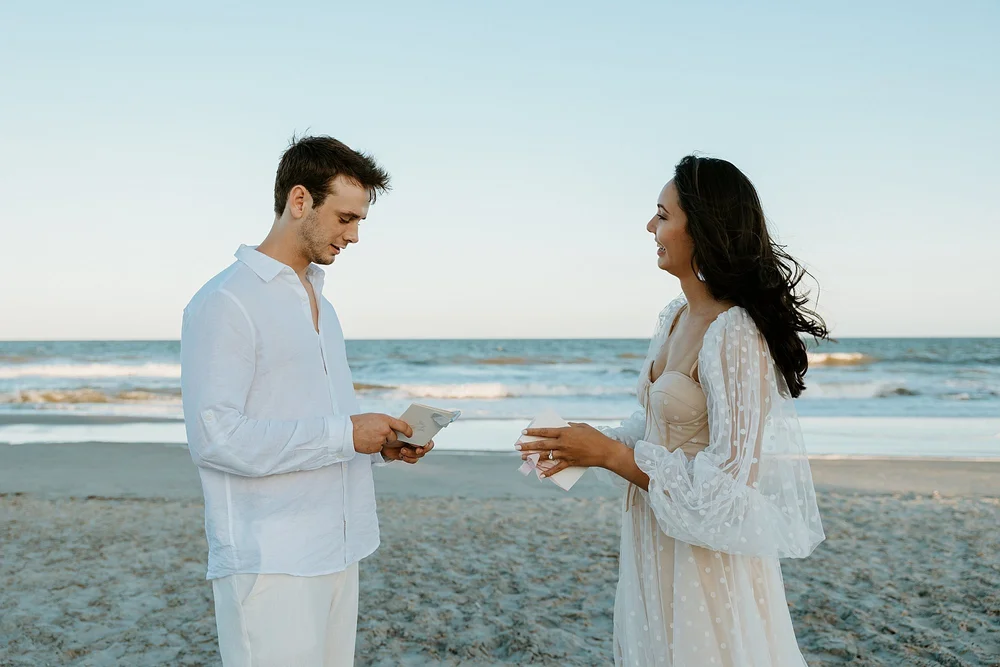 How to elope in Charleston SC - couple shares their vows together on the beach at sunset.