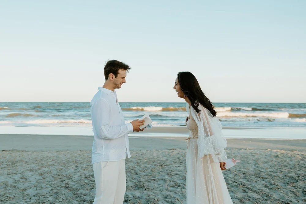 How to elope in Charleston SC - couple shares their vows together on the beach at sunset.