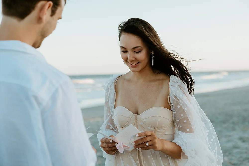How to elope in Charleston SC - couple shares their vows together on the beach at sunset.