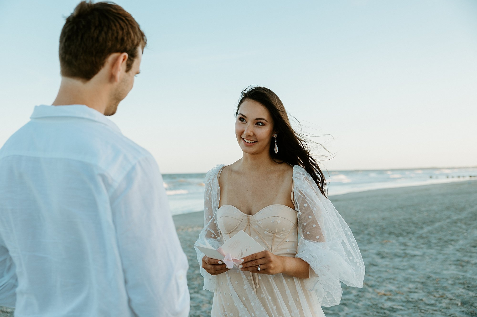 How to elope in Charleston SC - couple shares their vows together on the beach at sunset.