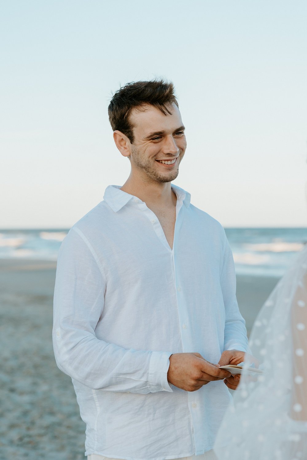 How to elope in Charleston SC - couple shares their vows together on the beach at sunset.