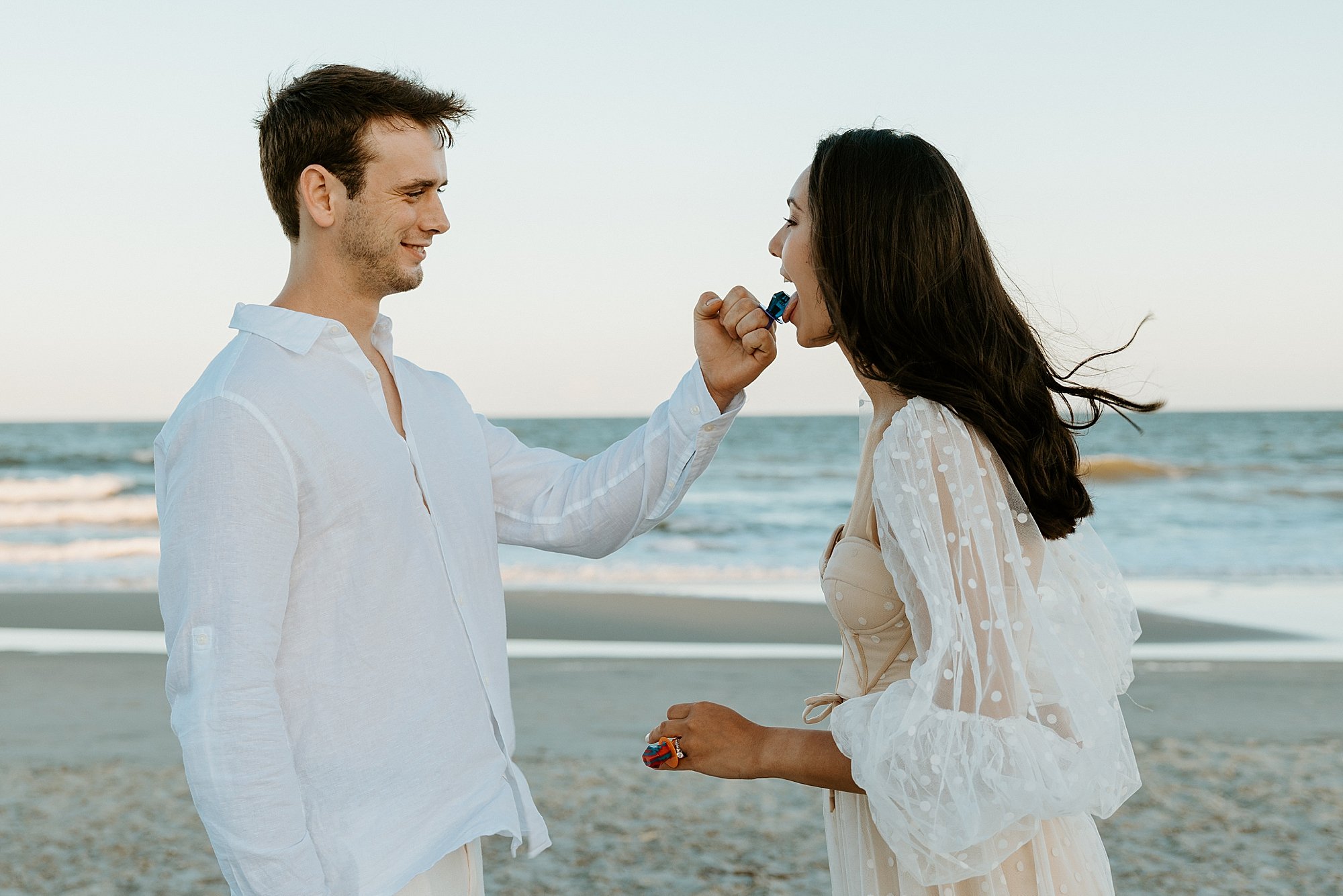 Groom lets the bride taste the ring pop that she gave him