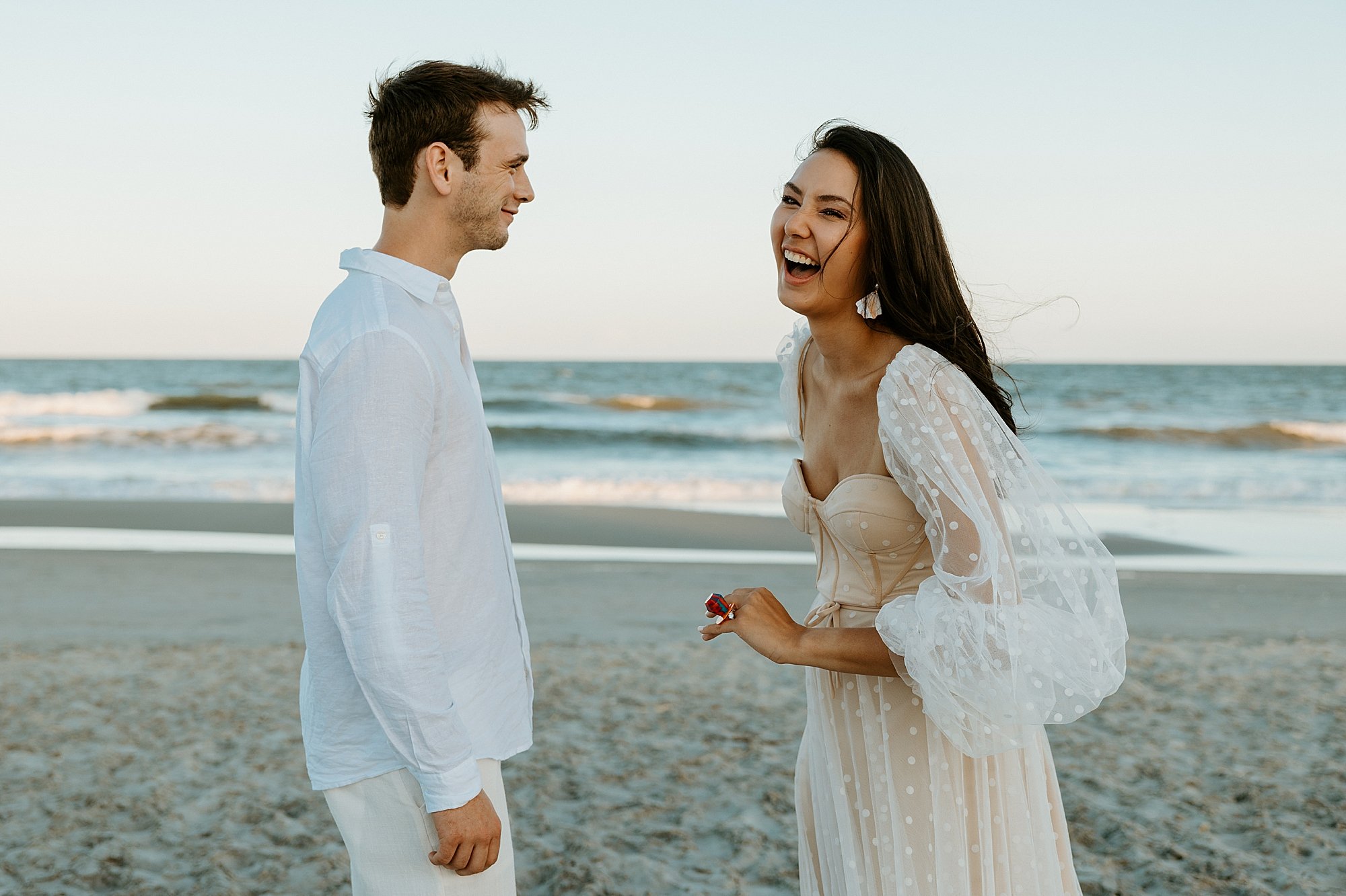 Couple laughs after their share their vows together on the beach in Charleston SC