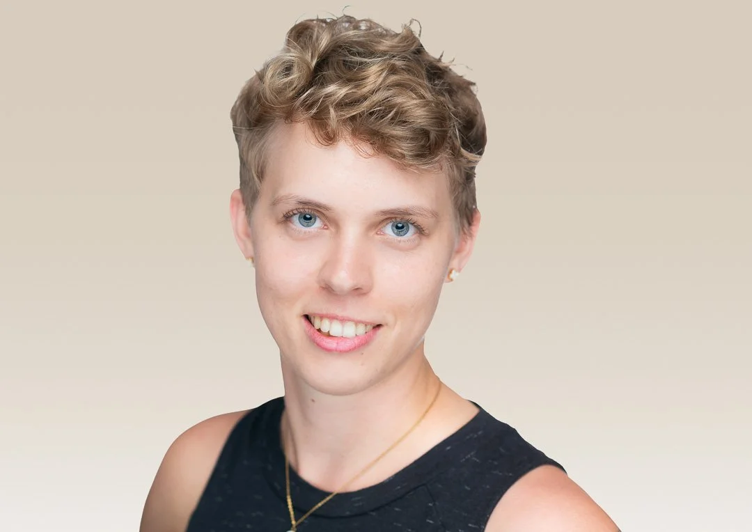 Relaxed studio portrait of a woman against a soft neutral background
