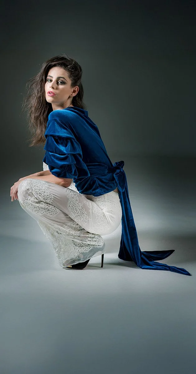 Fashion model in studio in a seated pose