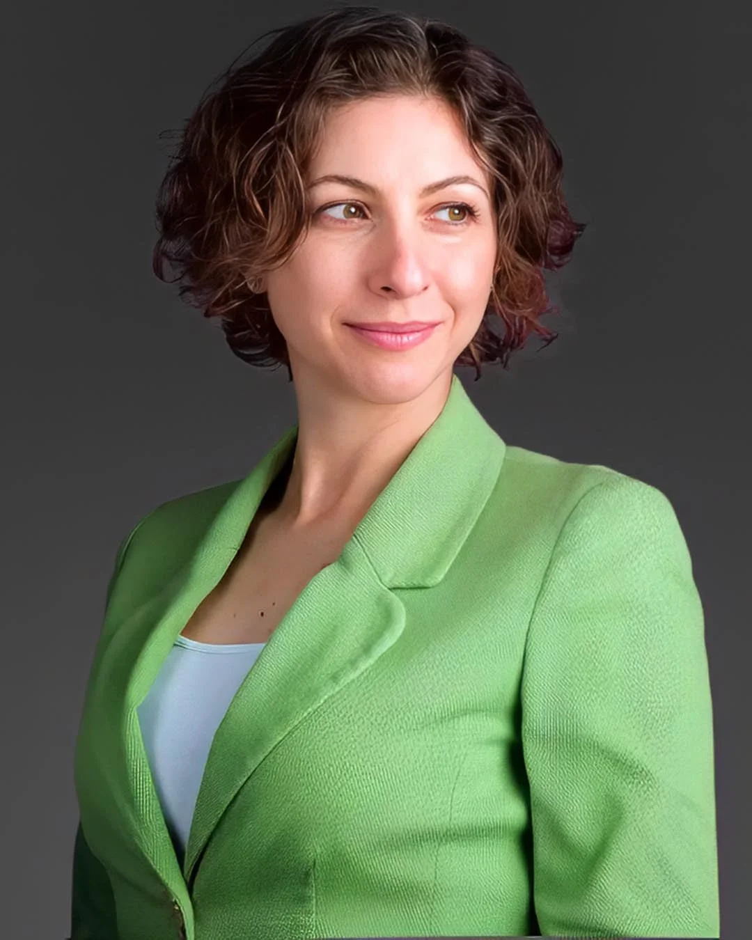 Personal branding portrait of a woman in a green jacket photographed in studio in the Algarve