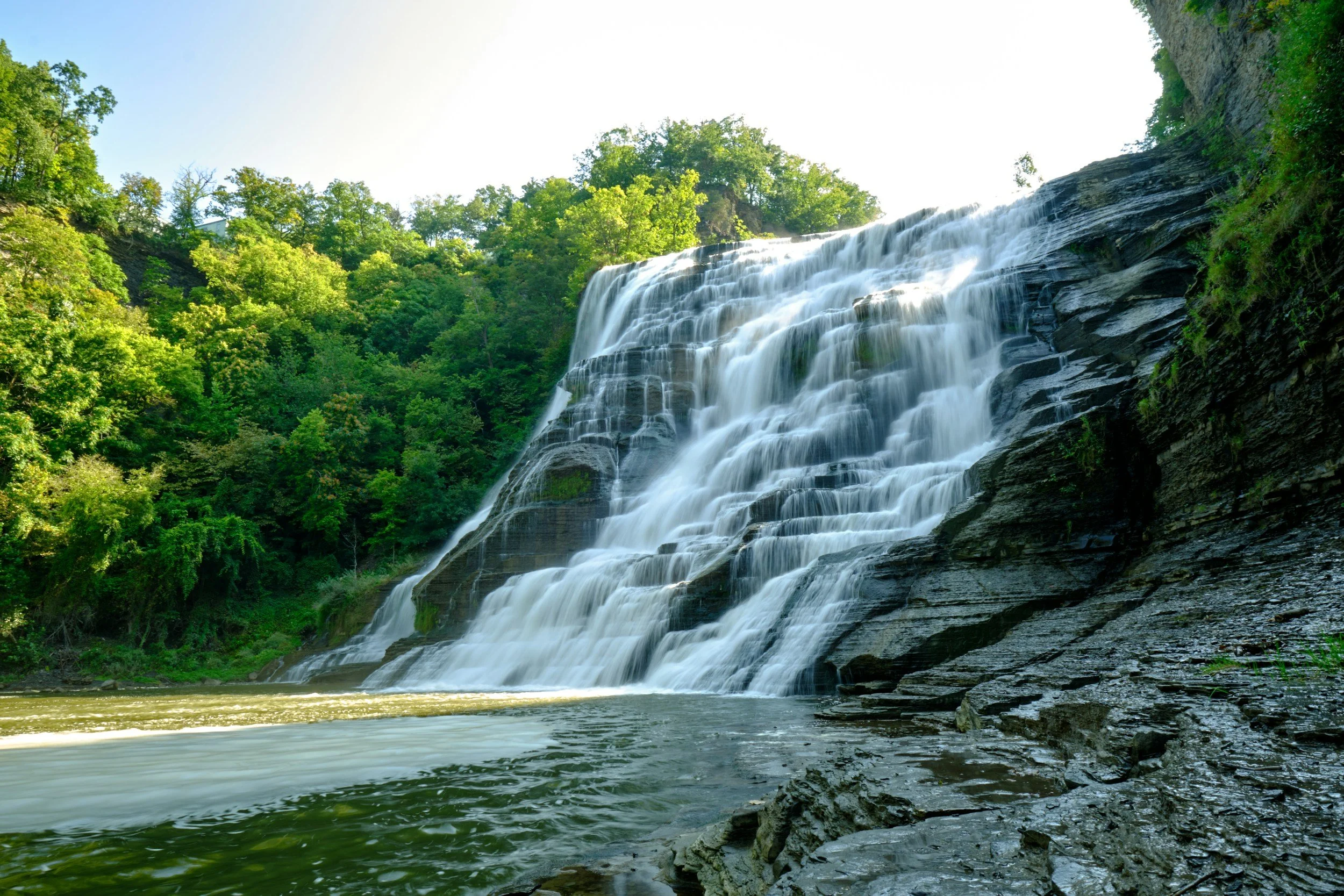 A large waterfall in the summertime