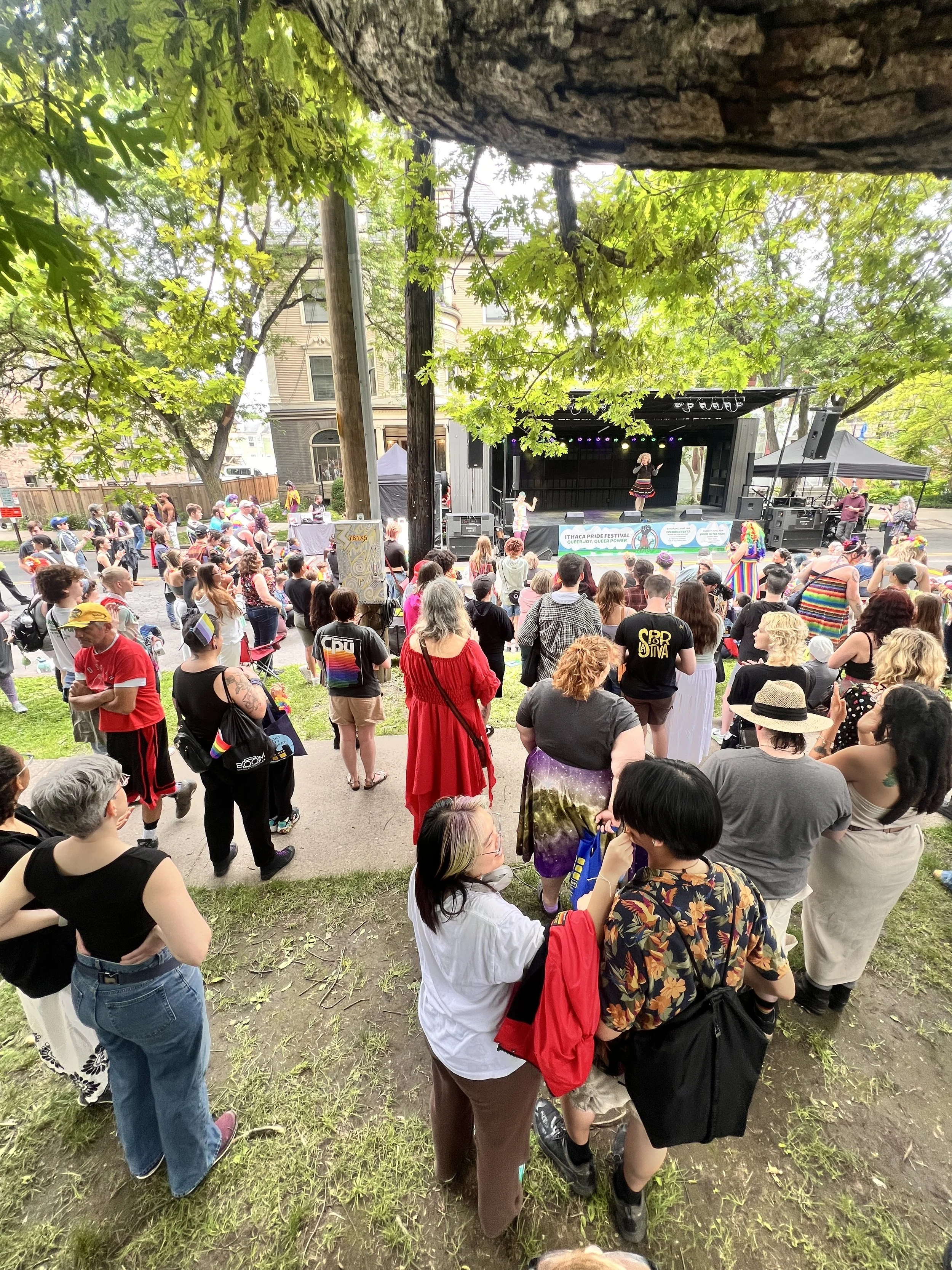 Large crowd faces a stage with drag performers