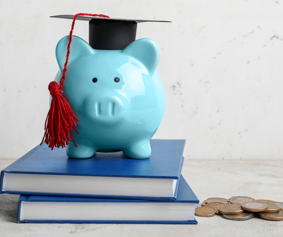 A piggy bank wearing a graduation cap, sitting on a stack of books