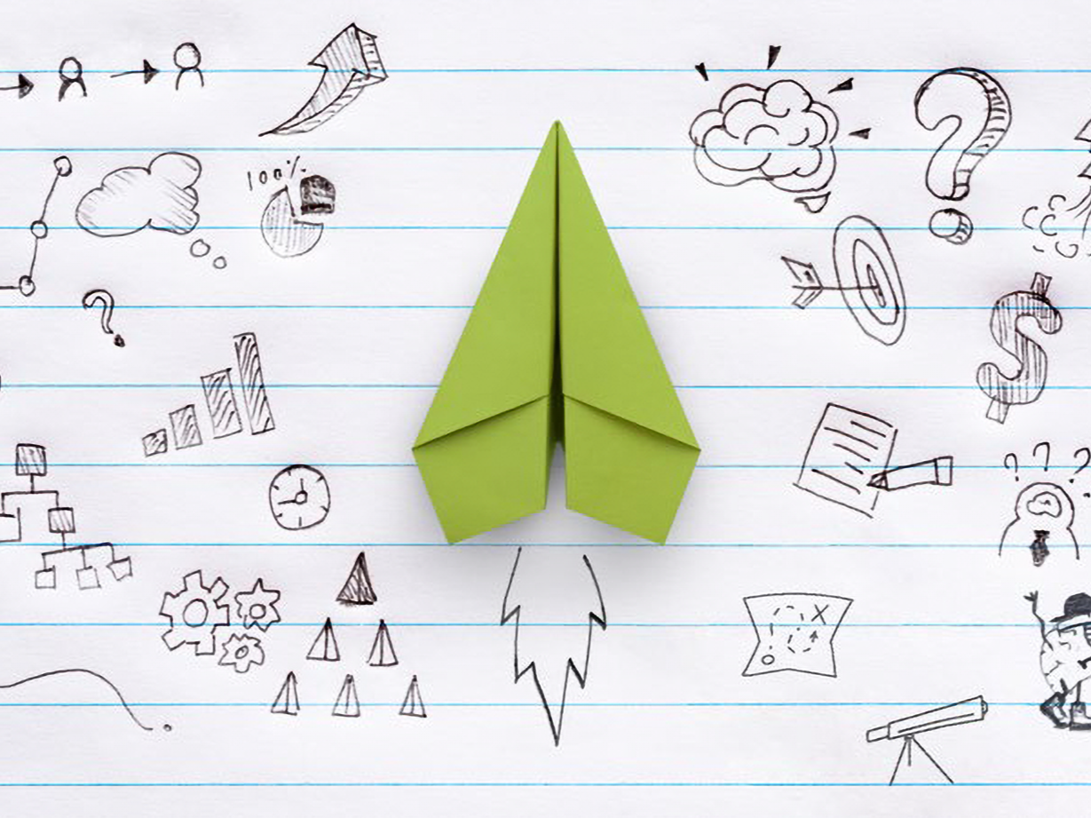 image of a red paper plane and business strategy with hand drawing on notebook 