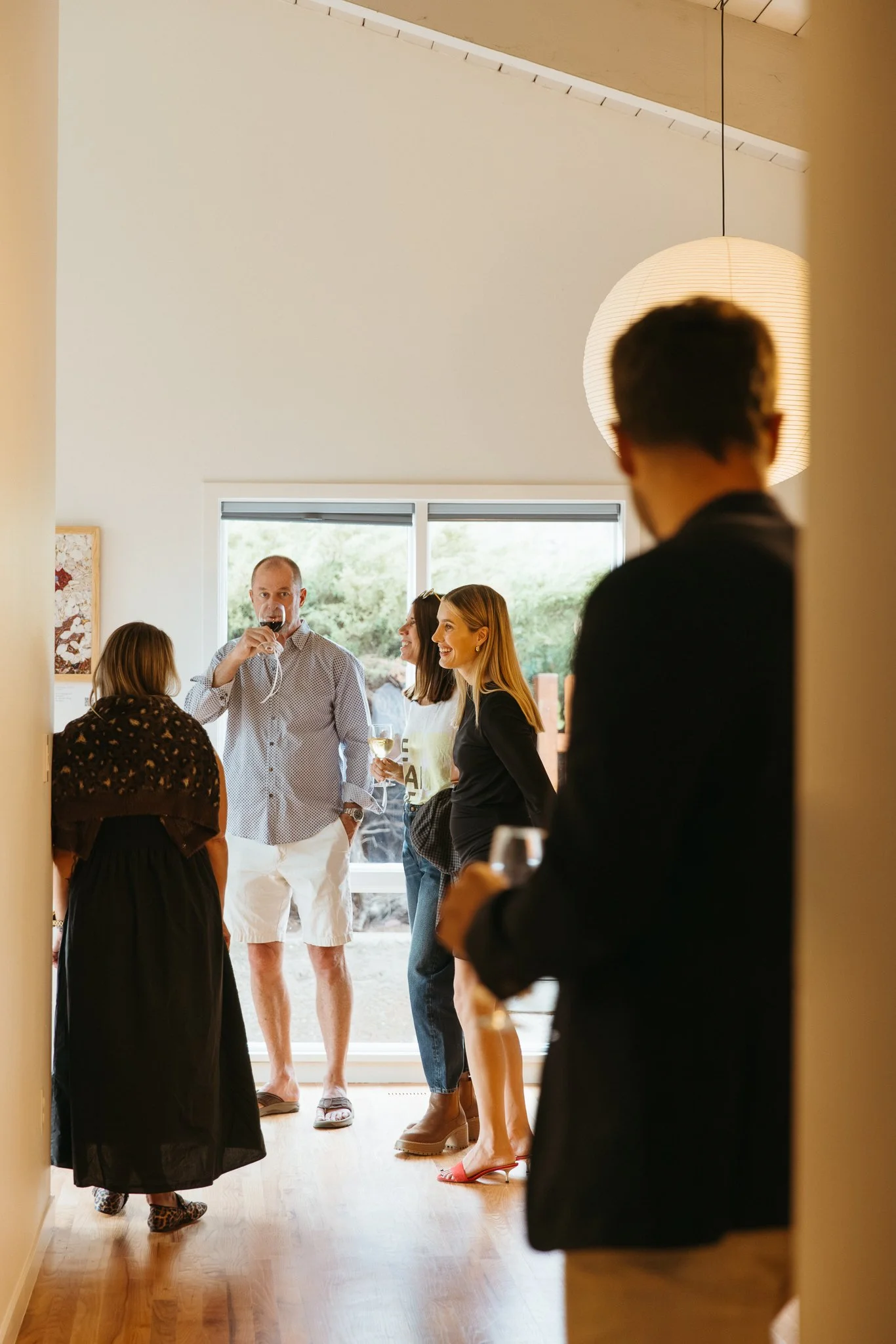 Guests gathered inside a modern gallery during the Verbunt Galerie launch party, photographed in Colorado.