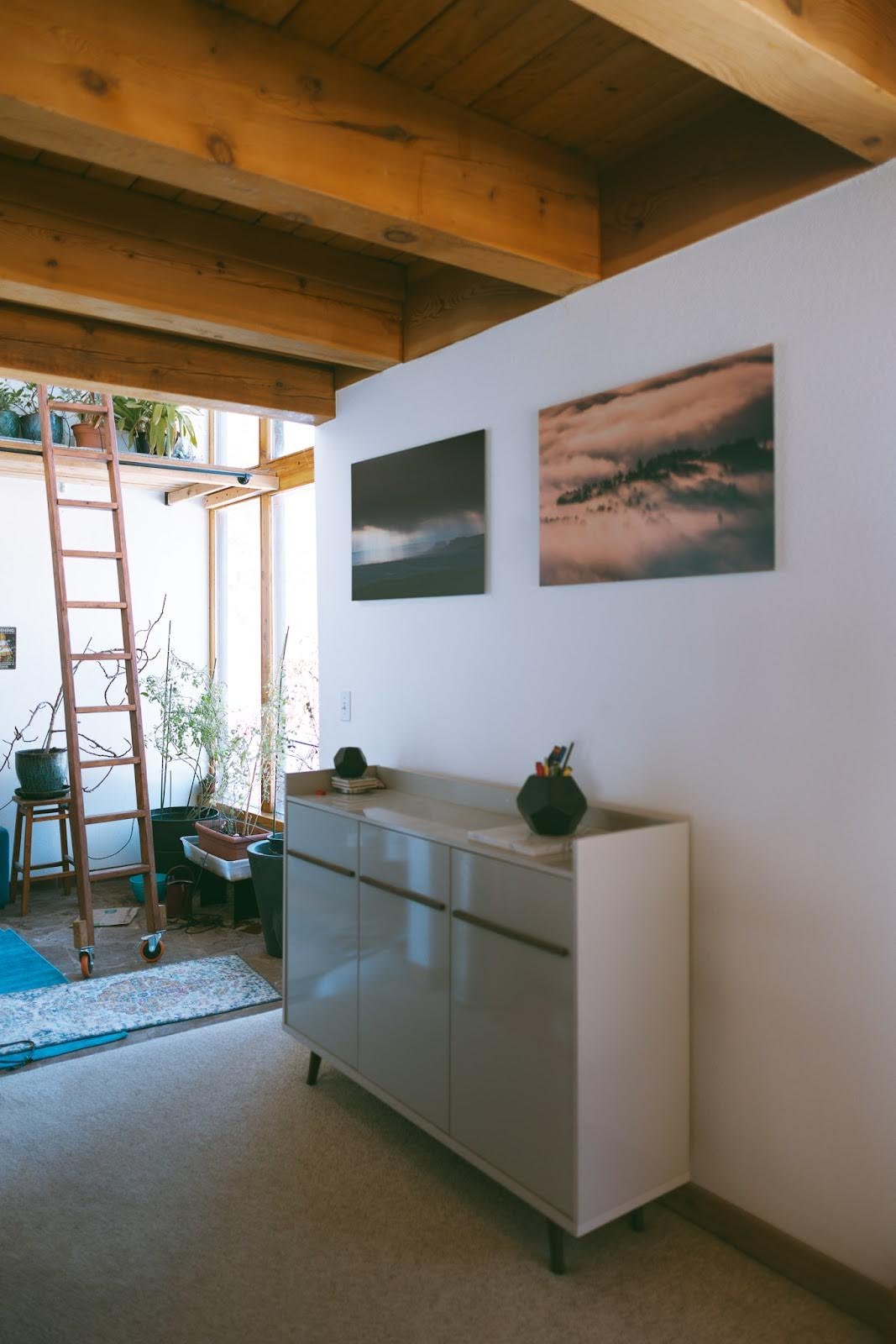 Interior detail of exposed wooden beams and staircase, showcasing craftsmanship and warm architectural elements