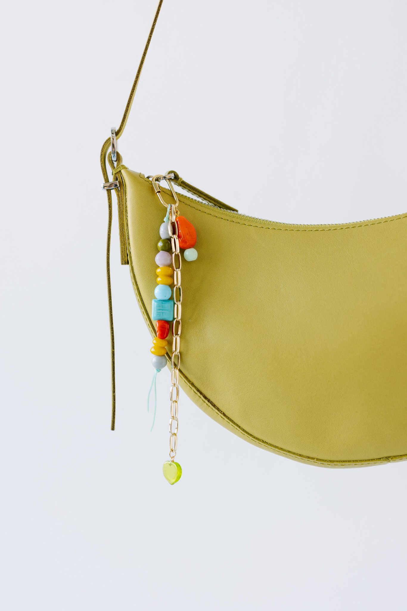 Green leather handbag with colorful bead and chain decoration