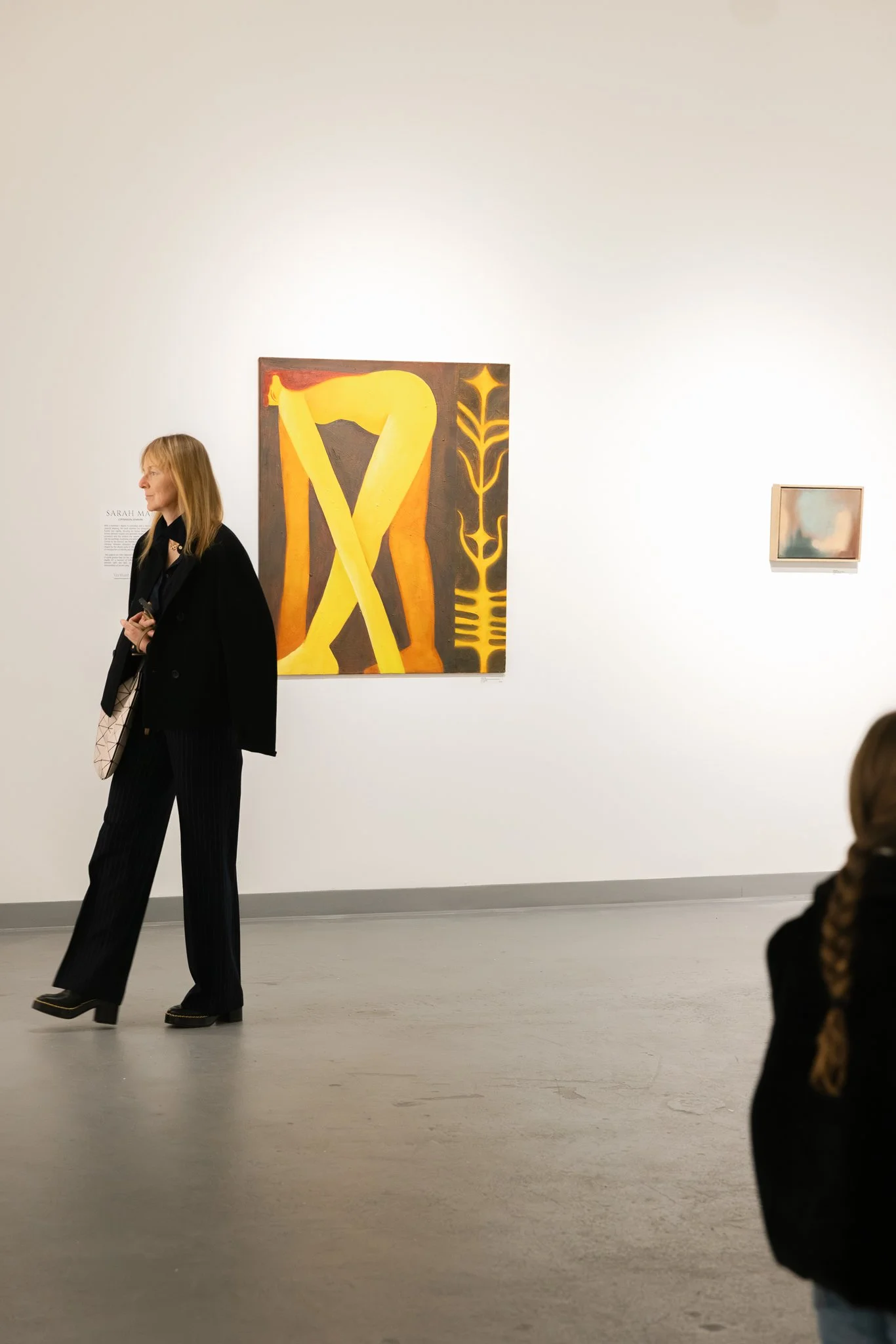Guests mingling and viewing artwork during the Verbunt Polyglot gallery opening event, photographed in Colorado.