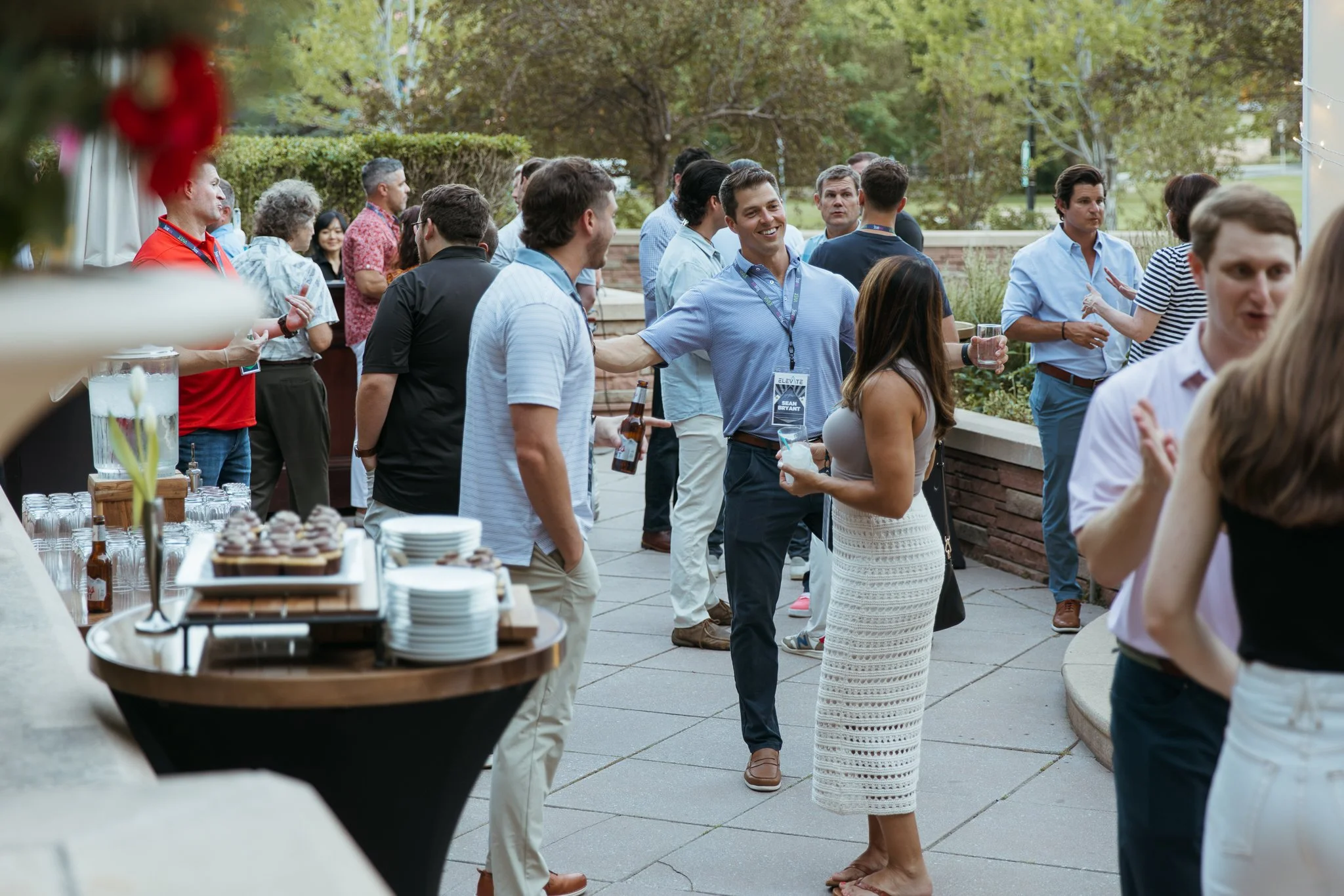 Colleagues networking during an outdoor company retreat reception and team gathering in Boulder, Colorado.